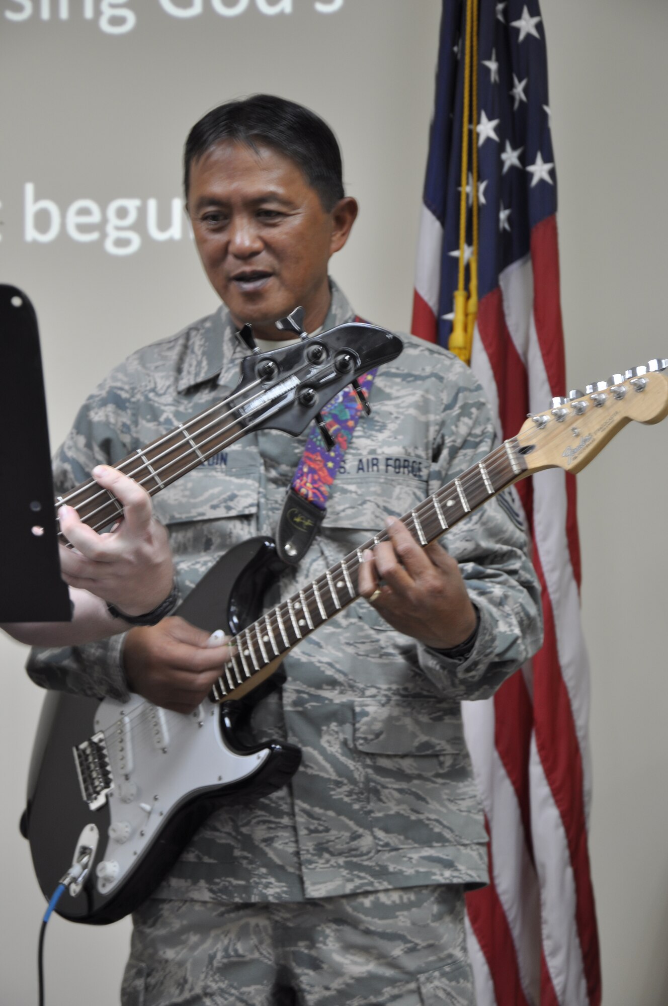 Master Sgt. Lazaro Joaquin, 332nd Expeditionary Communication Squadron, sings and plays guitar at the Martin Luther King Jr. Day celebration at the base chapel in an undisclosed location in Southwest Asia. Joaquin is deployed from the Hawaii Air National Guard. (photo by Senior Airman Melanie Holochwost)