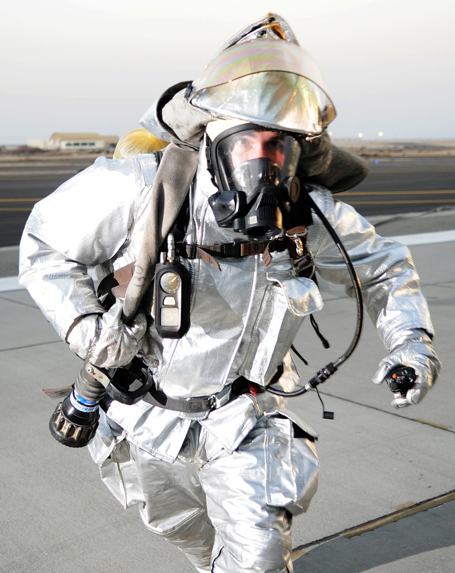 SOUTHWEST ASIA - Staff Sgt. Andrew Moore rushes into a KC-10 Extender to extinguish a mock fire during a major accident response exercise at the 380th Air Expeditionary Wing Jan. 18, 2012. The exercise tested the wing?s response capabilities in the event of a plane crash. In addition, members of the host nation air force partnered with the Airmen and Soldiers, ensuring a cohesive response to a real-world emergency. Moore is deployed from Joint Base Elmendorf-Richardson, Alaska. (U.S. Air Force photo/Staff Sgt. J.G. Buzanowski)