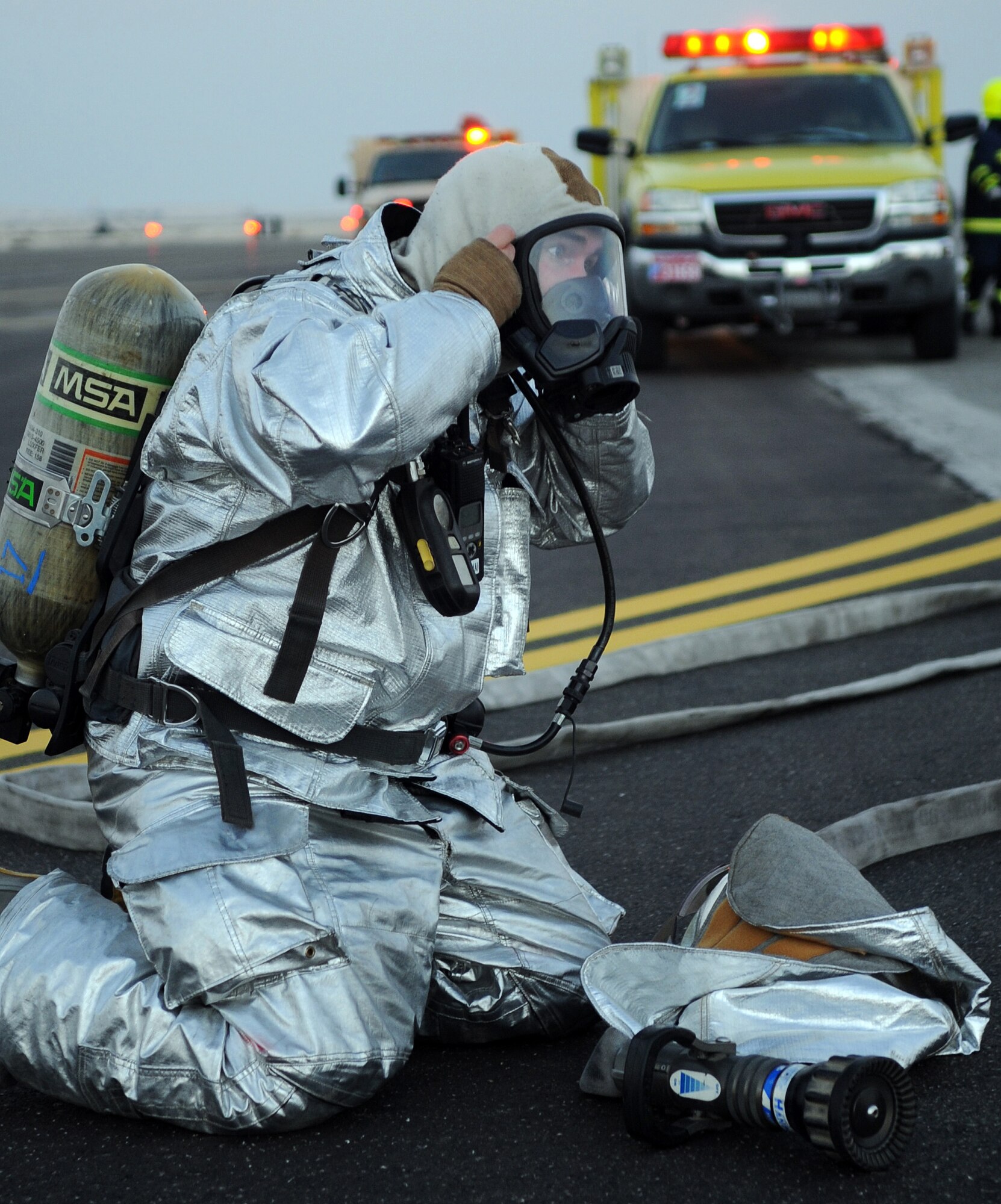 SOUTHWEST ASIA - Staff Sgt. Andrew Moore dons extra protective gear before rushing into a KC-10 Extender to extinguish a mock fire during a major accident response exercise at the 380th Air Expeditionary Wing Jan. 18, 2012. The exercise tested the wing?s response capabilities in the event of a plane crash. In addition, members of the host nation air force partnered with the Airmen and Soldiers, ensuring a cohesive response to a real-world emergency. Moore is deployed from Joint Base Elmendorf-Richardson, Alaska. (U.S. Air Force photo/Staff Sgt. J.G. Buzanowski)