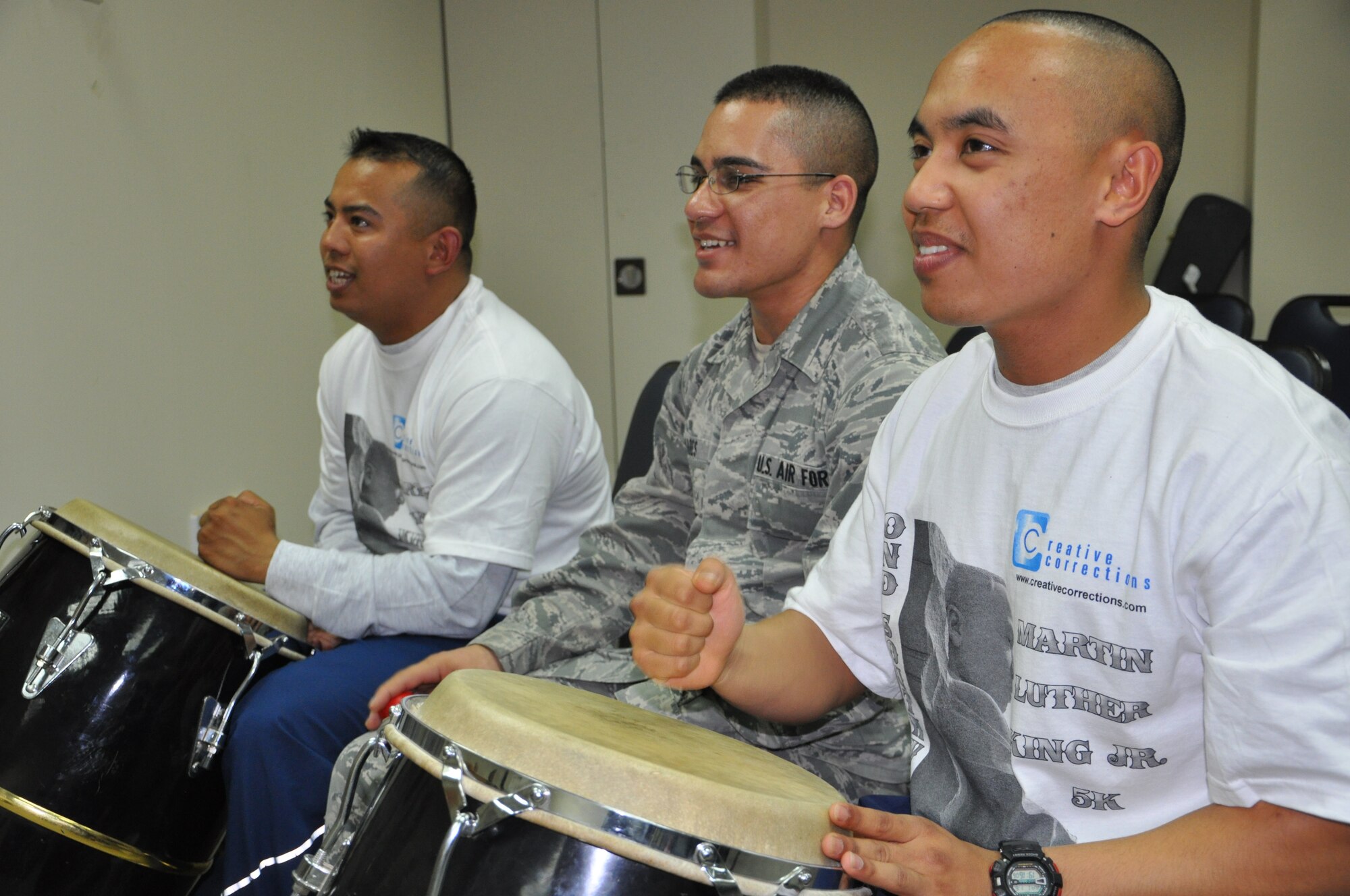 Staff Sgt. Joshua Garcia, 332nd Air Expeditionary Wing, Airman 1st Class Douglas Vares, 332nd Expeditionary Communications Squadron, and Senior Airman Michael Paredes, 332nd Expeditionary Mission Support Group, play percussion during the Martin Luther King Jr. Day celebration at the base chapel Jan. 16, 2012 at an undisclosed location in Southwest Asia. The band incorporates a variety of instruments including conga drums. Garcia is deployed from Moody Air Force Base, Ga., Vares from the Hawaii Air National Guard, and Paredes from Mountain Home Air Force Base, Idaho. (photo by Senior Airman Melanie Holochwost)   