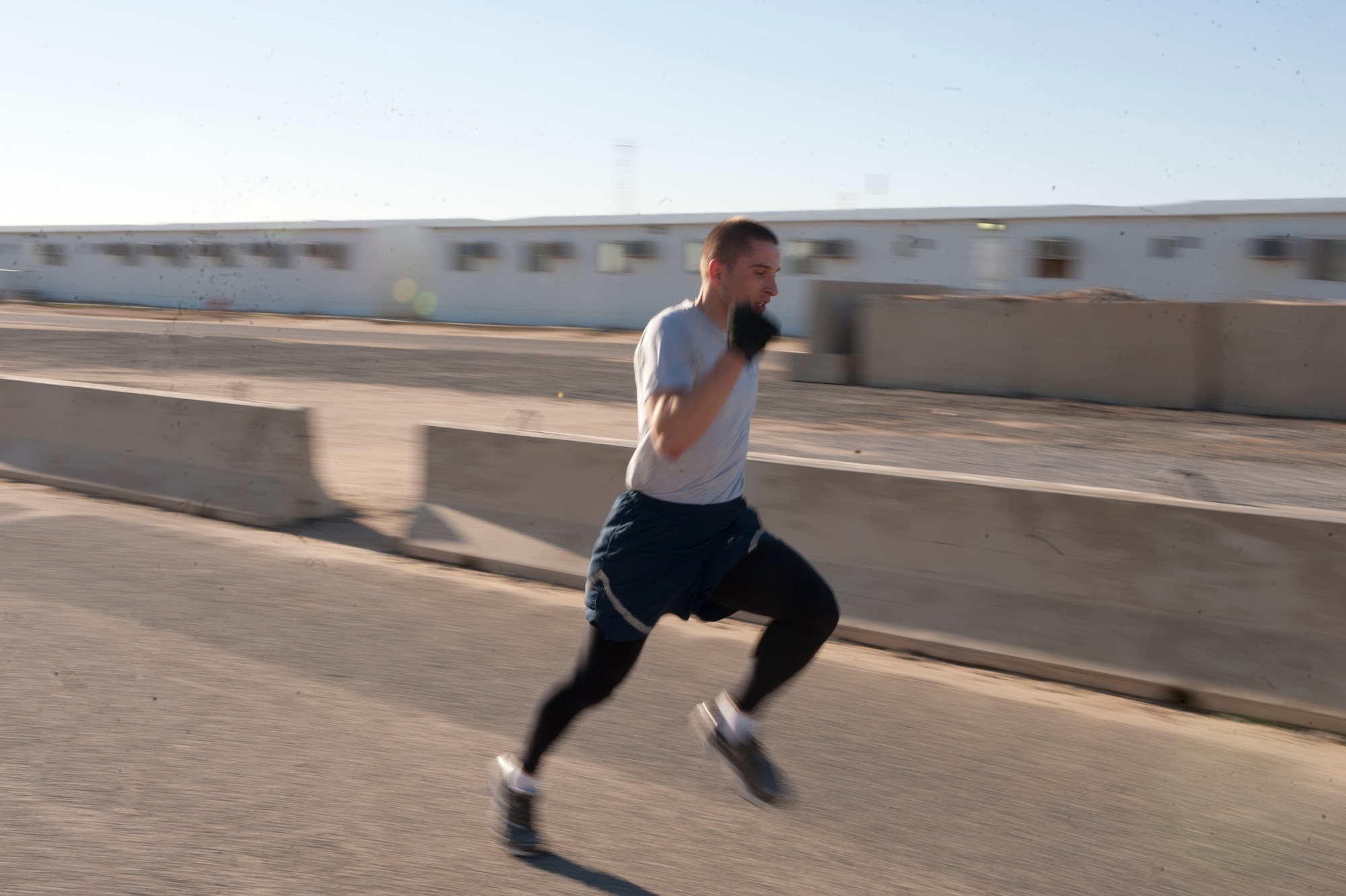 Staff Sgt. Ioan Gaitan, 332nd Expeditionary Civil Engineer Squadron, sprints to the finish line during the morning Martin Luther King 5K run at an undisclosed location Southwest Asia, Jan. 16, 2012. Gaitan placed first for the men’s category for the morning run, with a run time of 20:32. Gaitan is deployed from Nellis Air Force Base, Nev. (U.S. Air Force photo by Staff Sgt. Joshua J. Garcia/Released)