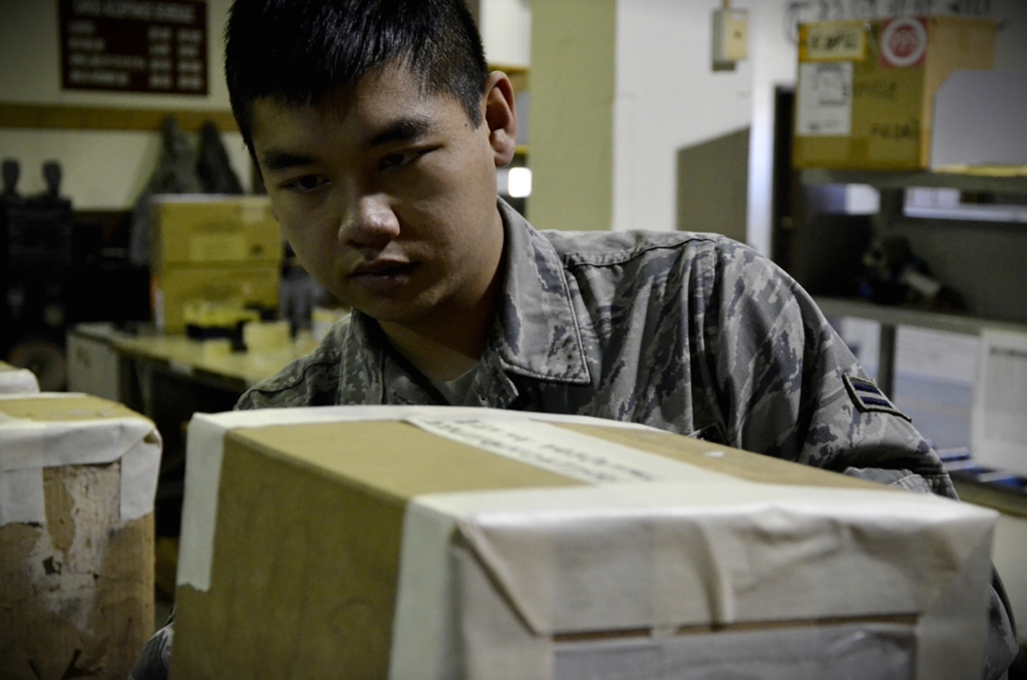 Airman 1st Class Francis Nguyen, 8th Logistics Readiness Squadron traffic management journeyman, ensures a series of boxes are properly labeled for shipment at Kunsan Air Base, Republic of Korea, Jan. 10, 2012. The traffic management flight has three distinct sections that routinely perform above and beyond, putting bread and bullets in the hands of the Wolf Pack. (U.S. Air Force photo by Senior Airman Benjamin Stratton/Released)