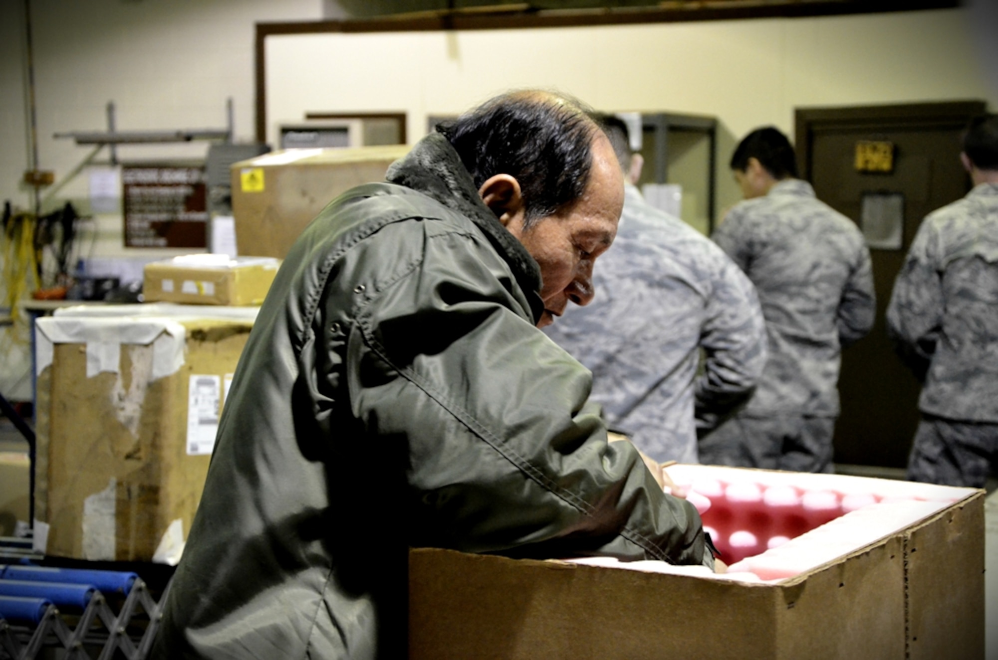 InChe So, 8th Logistics Readiness Squadron wood working specialist, prepares a box for shipment at Kunsan Air Base, Republic of Korea, Jan. 10, 2012. The traffic management flight has three distinct sections that routinely perform above and beyond, putting bread and bullets in the hands of the Wolf Pack. (U.S. Air Force photo by Senior Airman Benjamin Stratton/Released)