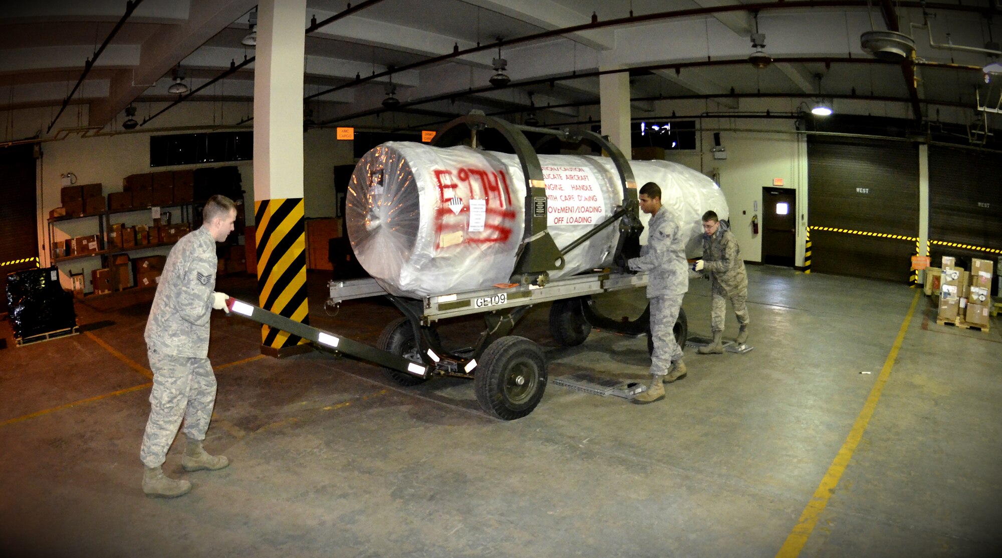 Traffic management flight Airmen from the 8th Logistics Readiness Squadron maneuver an F-16 Fighting Falcon engine around for shipment at Kunsan Air Base, Republic of Korea, Jan. 10, 2012. The traffic management flight has three distinct sections that routinely perform above and beyond, putting bread and bullets in the hands of the Wolf Pack. (U.S. Air Force photo by Senior Airman Benjamin Stratton/Released)
