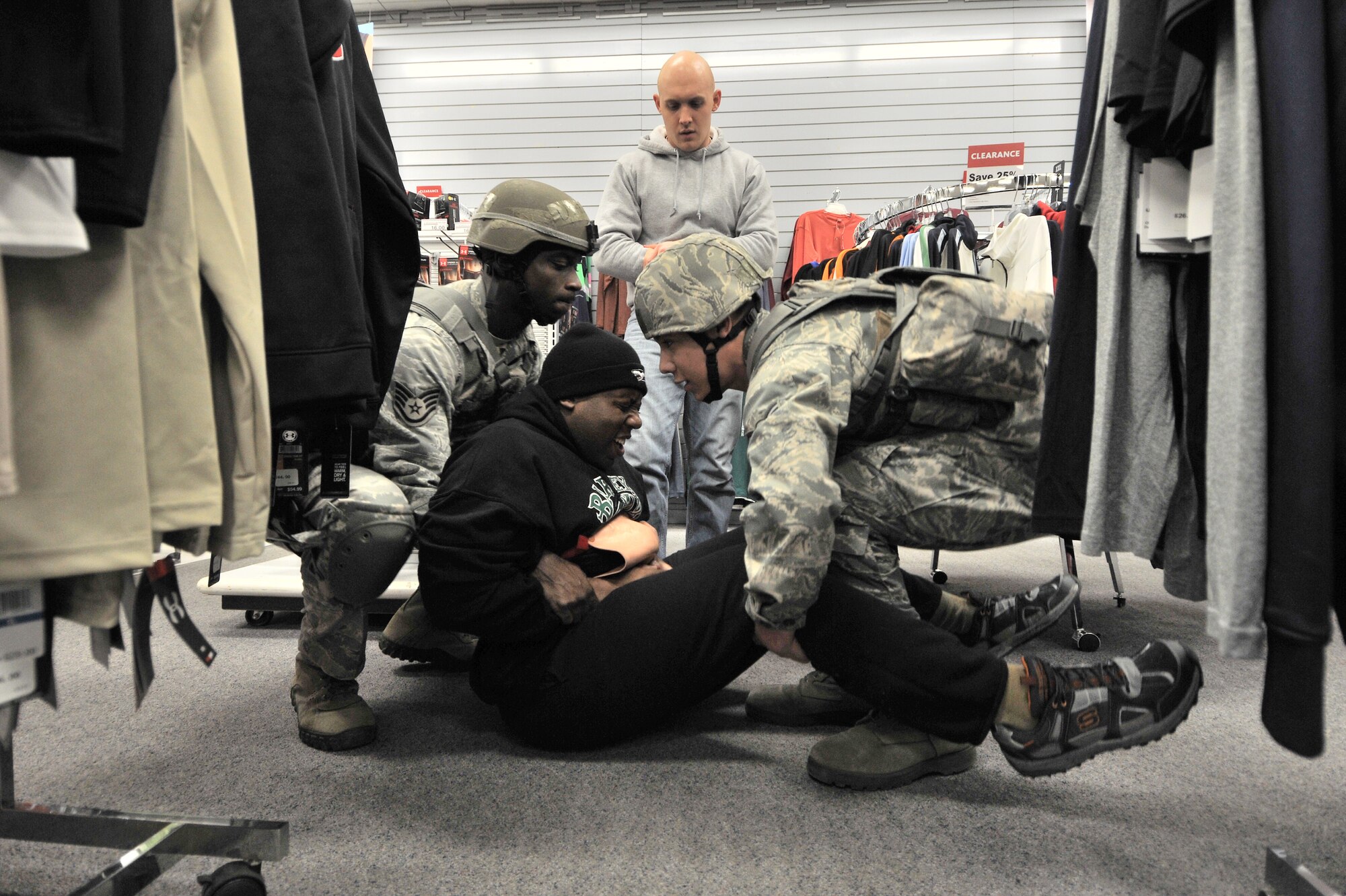 Members of the 8th Security Forces Squadron carry a victim to safety during the Pacific Air Forces’ High Risk Response Training at Kunsan Air Base, Republic of Korea, Jan. 13, 2012. The course provides effective response tactics to empower Pacific Air Forces security forces members to swiftly eliminate active shooter and other high risk response threats. (U.S. Air Force photo by Senior Airman Brittany Y. Auld/Released)