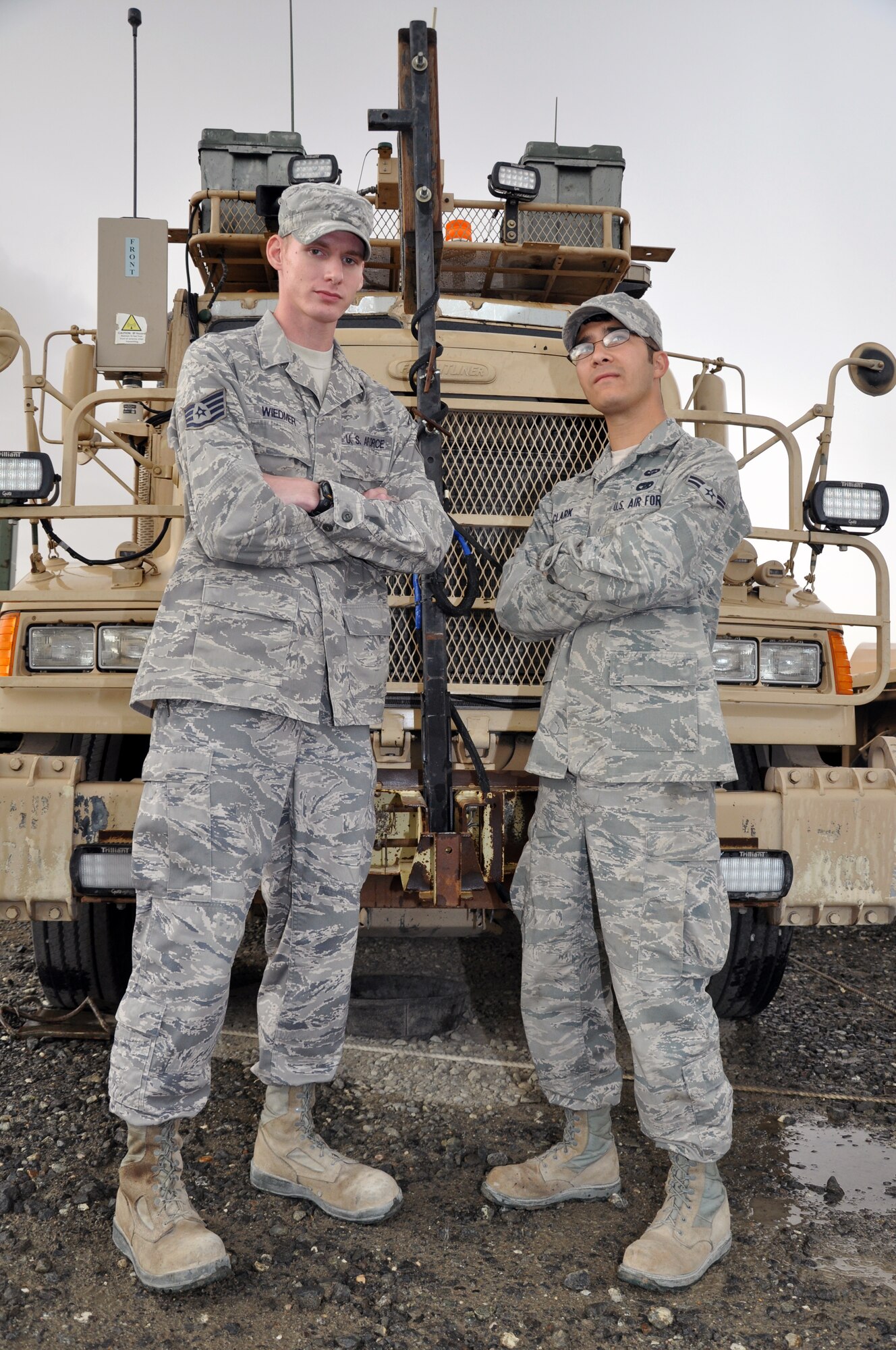 Staff Sgt. Christopher Wiedmer (left) was wounded when his vehicle was struck by an improvised explosive device during the completion of Operation New Dawn. Airman 1st Class Daniel Clark (right) was driving that day and was uninjured in the attack. Both Airmen are assigned to the 387th Expeditionary Logistics Readiness Squadron. Wiedmer was awarded the Purple Heart, and both Wiedmer and Clark received the Army Combat Action Badge and Army Commendation Medals, as well as the Air Force Combat Action Medal.   (U.S. Air Force photo/Tech. Sgt. Stacy Fowler)