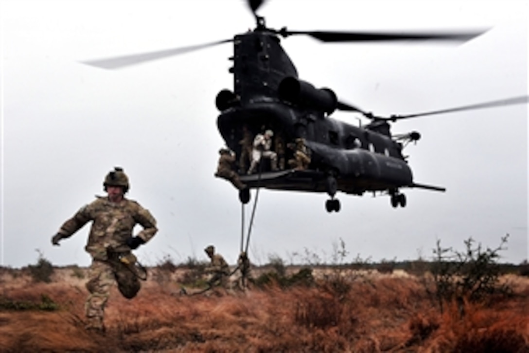 Rangers rappel out the back of a CH-47 Chinook helicopter while participating in a combined arms live-fire exercise near Fort Stewart, Ga., on Jan. 10, 2012.  The Rangers are assigned to the 1st Battalion, 75th Ranger Regiment.  The exercise is conducted to evaluate and train members on de-escalation of force, reactions to enemy contact and other objectives that prepare them for forward operations.  