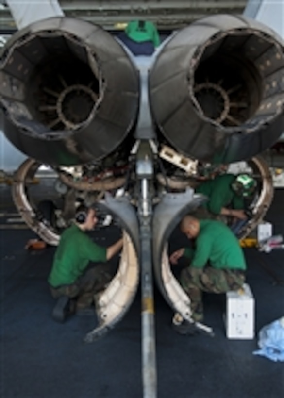 Sailors perform maintenance on an F/A-18E Super Hornet from Strike Fighter Squadron 14 aboard the aircraft carrier USS John C. Stennis (CVN 74) in the Arabian Sea on Jan. 13, 2012.  The John C. Stennis is deployed to the U.S. 5th Fleet area of responsibility conducting maritime security operations and support missions as part of Operation Enduring Freedom.  