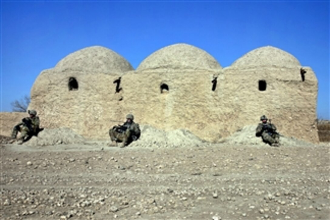 U.S. Army soldiers lean against a mud wall during a break from combat operations in Kandahar province's southern Spin Boldak district in Afghanistan on Jan. 9, 2012.  The soldiers are assigned to the 504th Battlefield Brigade's 38th Cavalry Regiment, 2nd Squadron.  