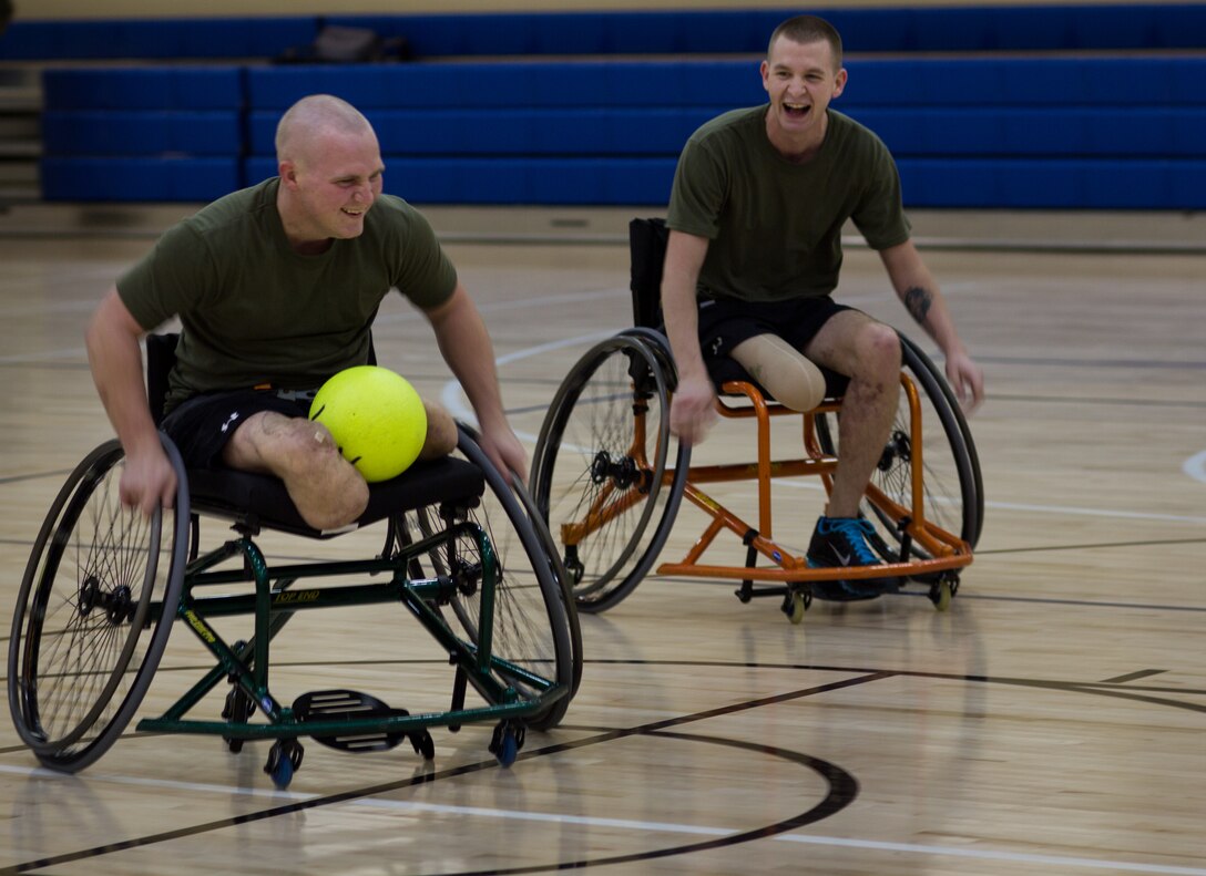 Lance Cpl. Tony Mullis and Lance Cpl. Derrick Stevenson race down the court during an improvised wheelchair soccer game at the Walter Reed National Military Medical Center Bethesda, Md., Jan. 10. They were part of 17 Marine class who recently graduated from the first corporals course for the Wounded Warrior Detachment.