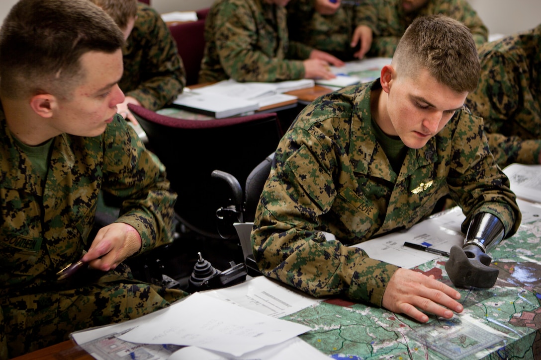 Cpl. Tyler J. Southern and Cpl. Todd Love plot a course on the map during the land navigation part of corporals course at the Walter Reed National Military Medical Center Bethesda, Md., Jan. 12. These Marines were part of the first Wounded Warrior Detachment corporals course.