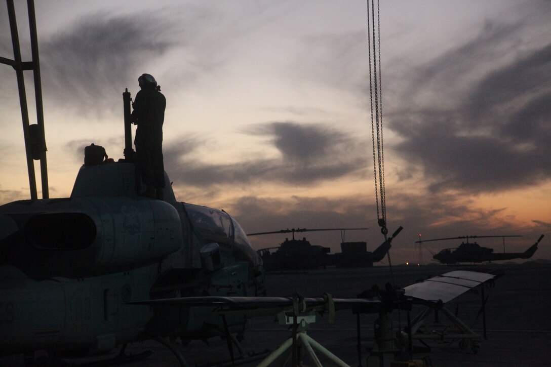 Lance Cpl. Mark Sabatino, a plane captain with the “Gunfighters” of Marine Light Attack Helicopter Squadron 369, and a native of Denver, performs maintenance on an AH-1W Super Cobra at Camp Bastion, Afghanistan, Jan. 19. The Gunfighters wield the only Marine Corps attack helicopters in Afghanistan and provide close air support for coalition forces operating in southwestern Afghanistan.