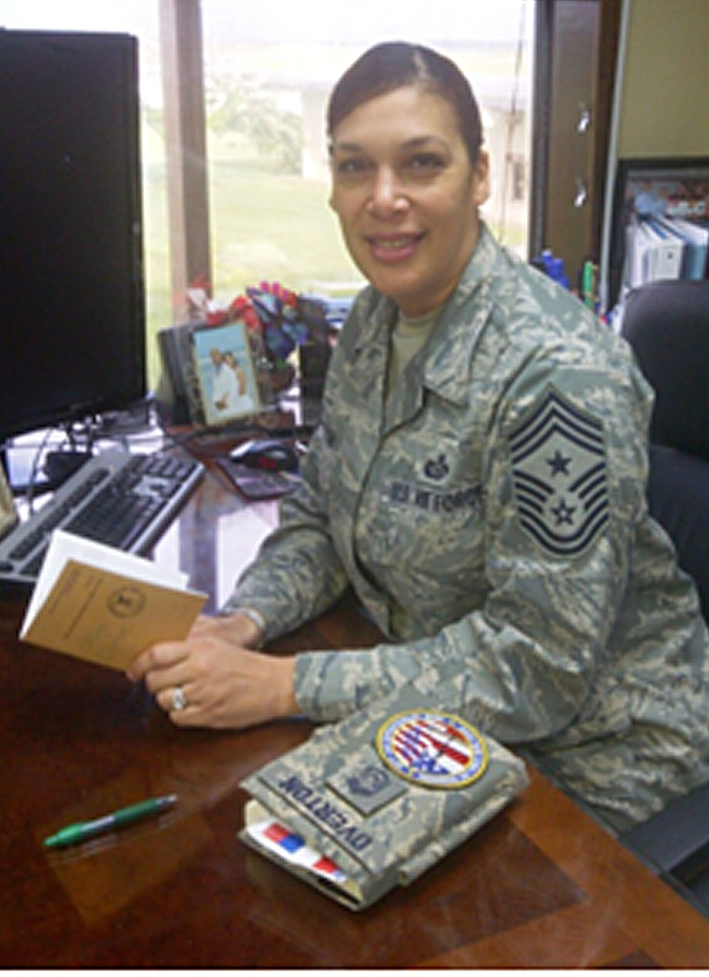 Command Chief Master Sgt. Margarita Overton sits at her desk asking Airmen, "whats on your 'not-to-do' list this year?"  (U.S. Air Force photo/Tech. Sgt. Danielle Spencer)