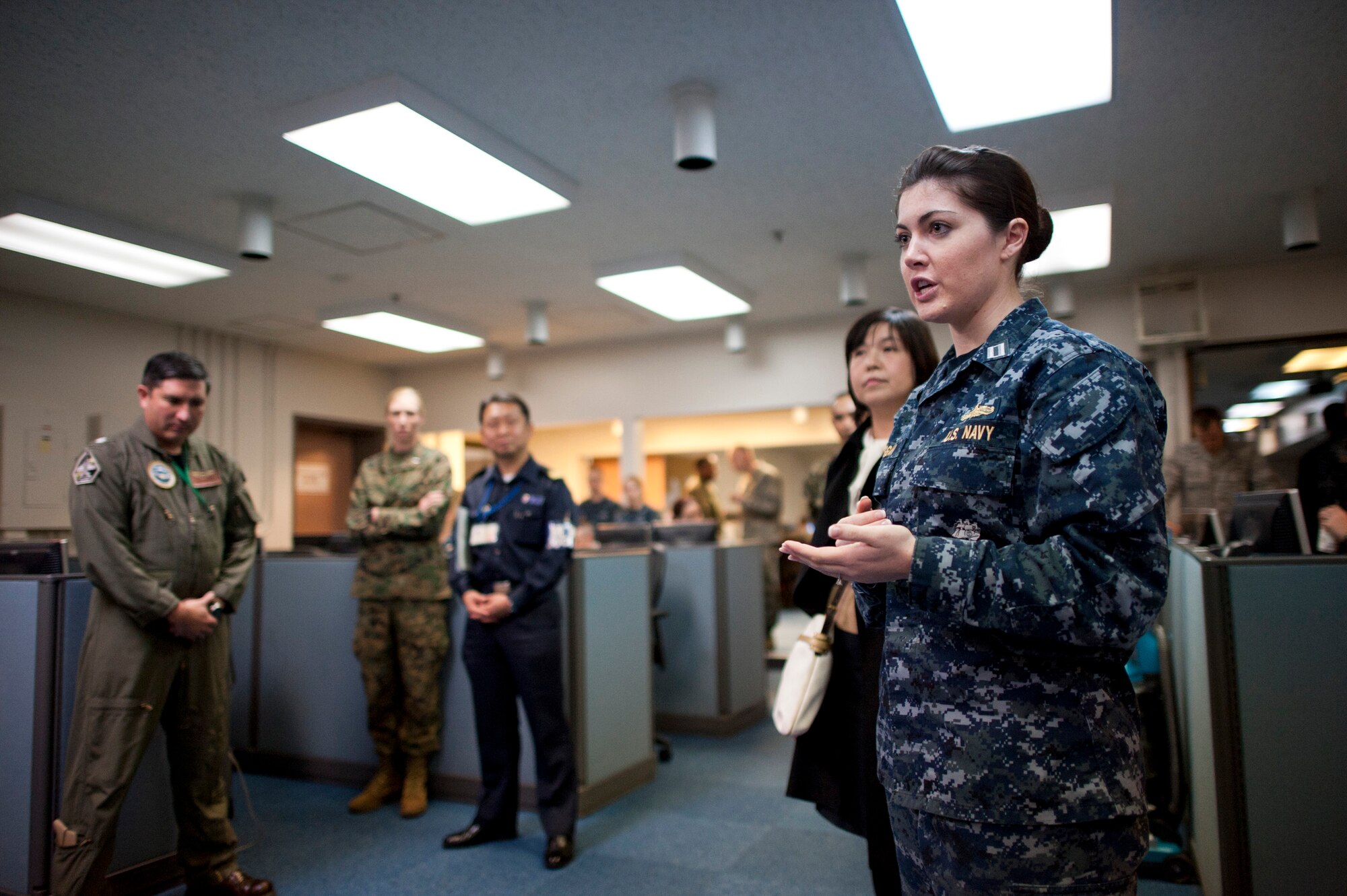 YOKOTA AIR BASE, Japan -- U.S. Navy Lt. Emily Duggan, U.S. Forces, Japan, operations officer, talks about the function of the Bilateral Joint Operations Coordination Center at Yokota Air Base, Japan, Jan. 19, 2012. The BJOCC will be used heavily in the upcoming exercise, Keen Edge 2012, the latest in a series of joint/bilateral command post exercises involving U.S. military and Japan Self-Defense Forces personnel designed to increase combat readiness and interoperability of U.S. and Japanese forces. (U.S. Air Force photo/Staff Sgt. Samuel Morse)