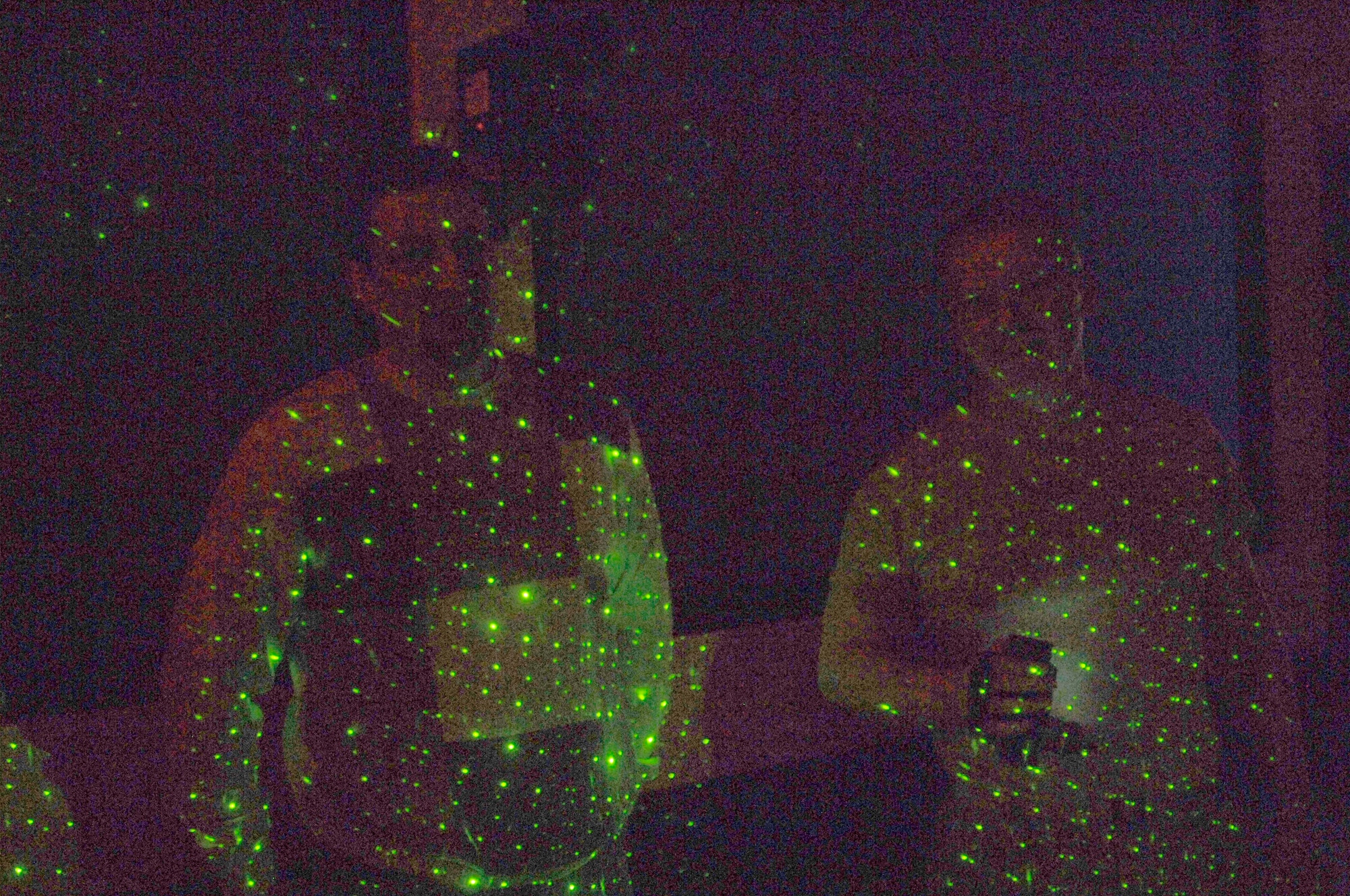 Josh Burger, a Schriever contractor, and Capt. Stan Maczek, 1st Space Operations Squadron, demonstrate an infrared motion sensor camera and an electro-magnetic field detector here Jan. 18. Burger and Maczek use both tools during their paranormal activity investigations. (U.S. Air Force photo\Scott Prater)