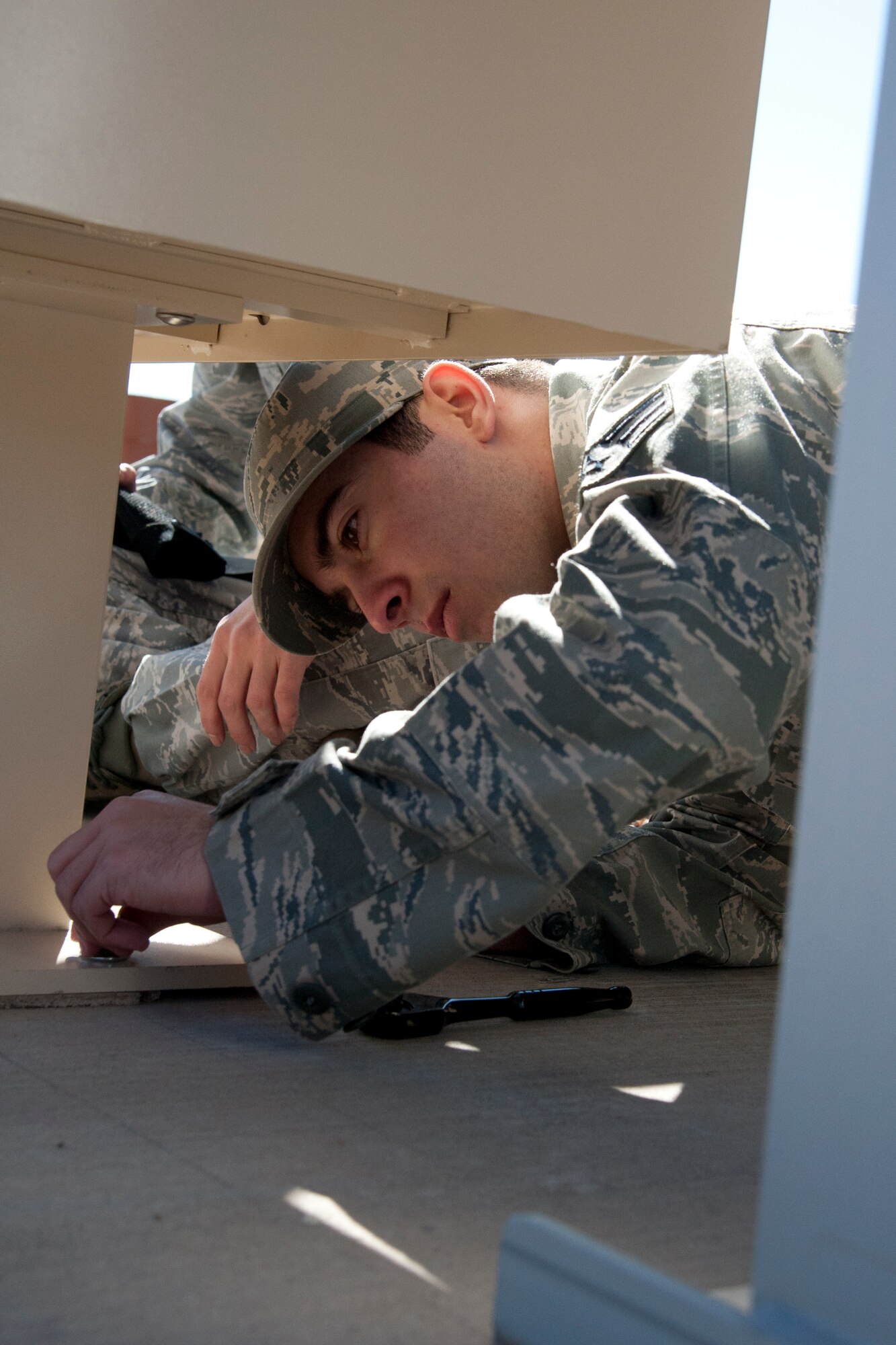 HOLLOMAN AIR FORCE BASE, N.M. – U.S. Air Force Senior Airman Antonio LaBella, 49th Communications Squadron, tightens a bolt to hold a new mailbox unit in place Jan. 13. LaBella was one of several volunteers from the 49th CS working on a project to install new mailboxes throughout the entire Holloman dormitory complex. This self-help project will save the Air Force an estimated $100,000 and improve the quality of living for approximately 560 Airmen residing in the dormitories.  (U.S. Air Force Photo by Airman 1st Class Anthony M. Ward / Released)