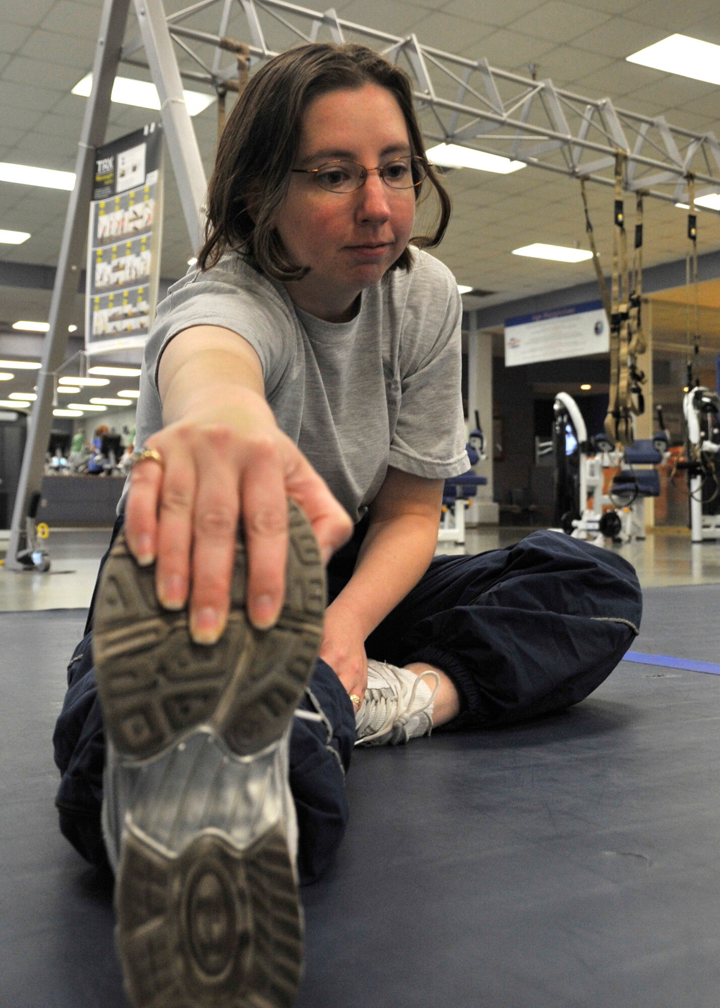 Tech. Sgt Jennifer Wallace stretches after a run inside the fitness center at Fairchild Air Force Base Jan. 17. Wallace sustained injury to her knees, threatening her career in the military. After a long process challenging the Informal Physical Evaluation Board, she finally reenlisted in December, 2011. (U.S. Air Force photos by Airman 1st Class Mary O’Dell) 