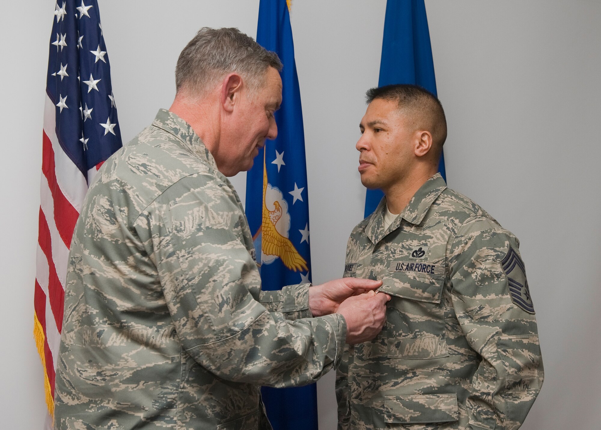 Alston awards a Bronze Star medal to Chief Master Sgt. Kyle Marquez. (U.S. Air Force photo/Beau Wade)