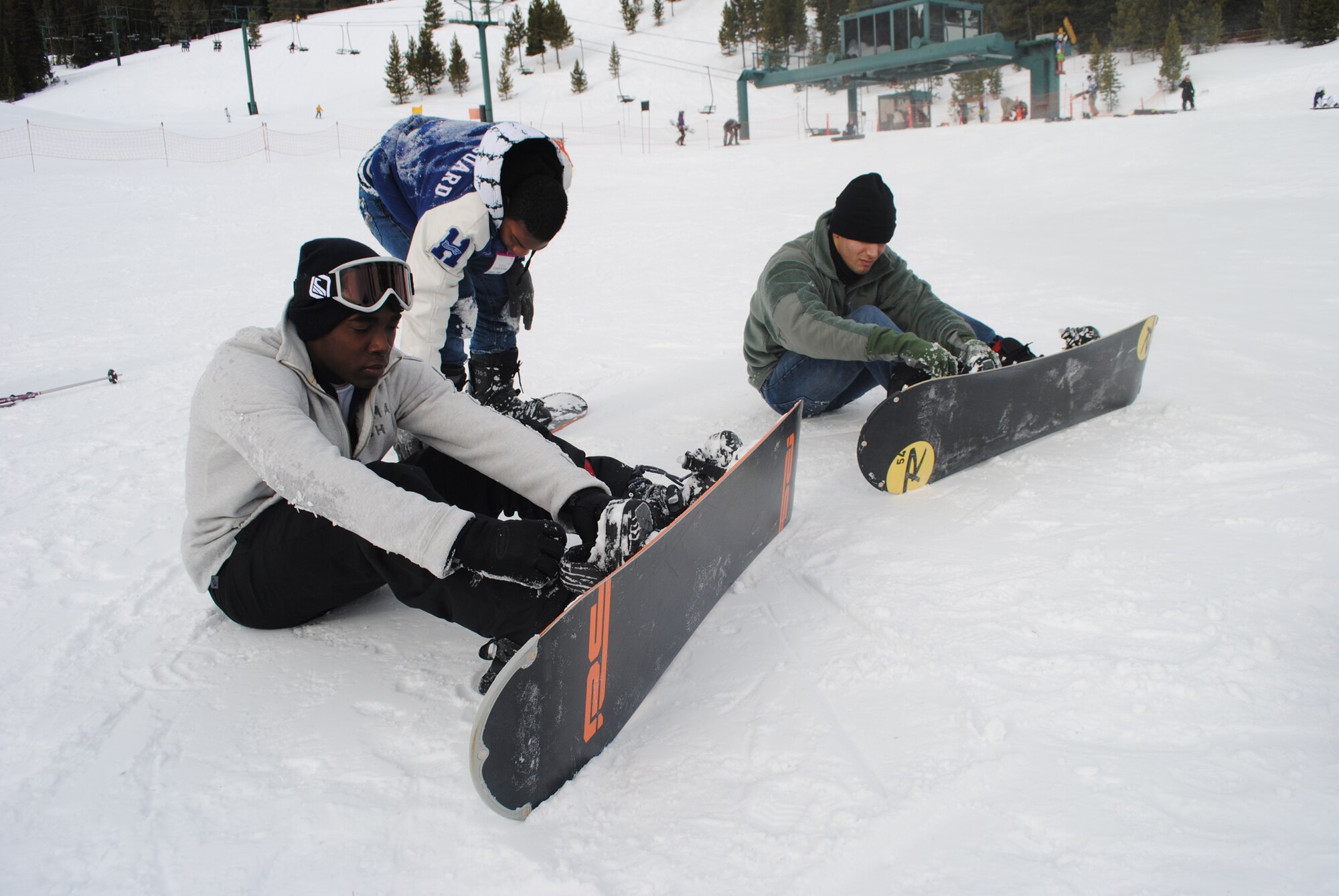 From left, Airman 1st Class Trey Barbour, 341st Missile Maintenance Squadron apprentice, Airman 1st Class Lester Brewer, Logistics Readiness Squadron apprentice, and Airman 1st Class Daniel Curdoza, 341st MMXS apprentice, attach snowboards to their boots at Showdown Ski Area Jan. 14. More than 20 members of Team Malmstrom participated in the ski trip, sponsored by the Detour.(U.S. Air Force photo/Airman 1st Class Katrina Heikkinen)