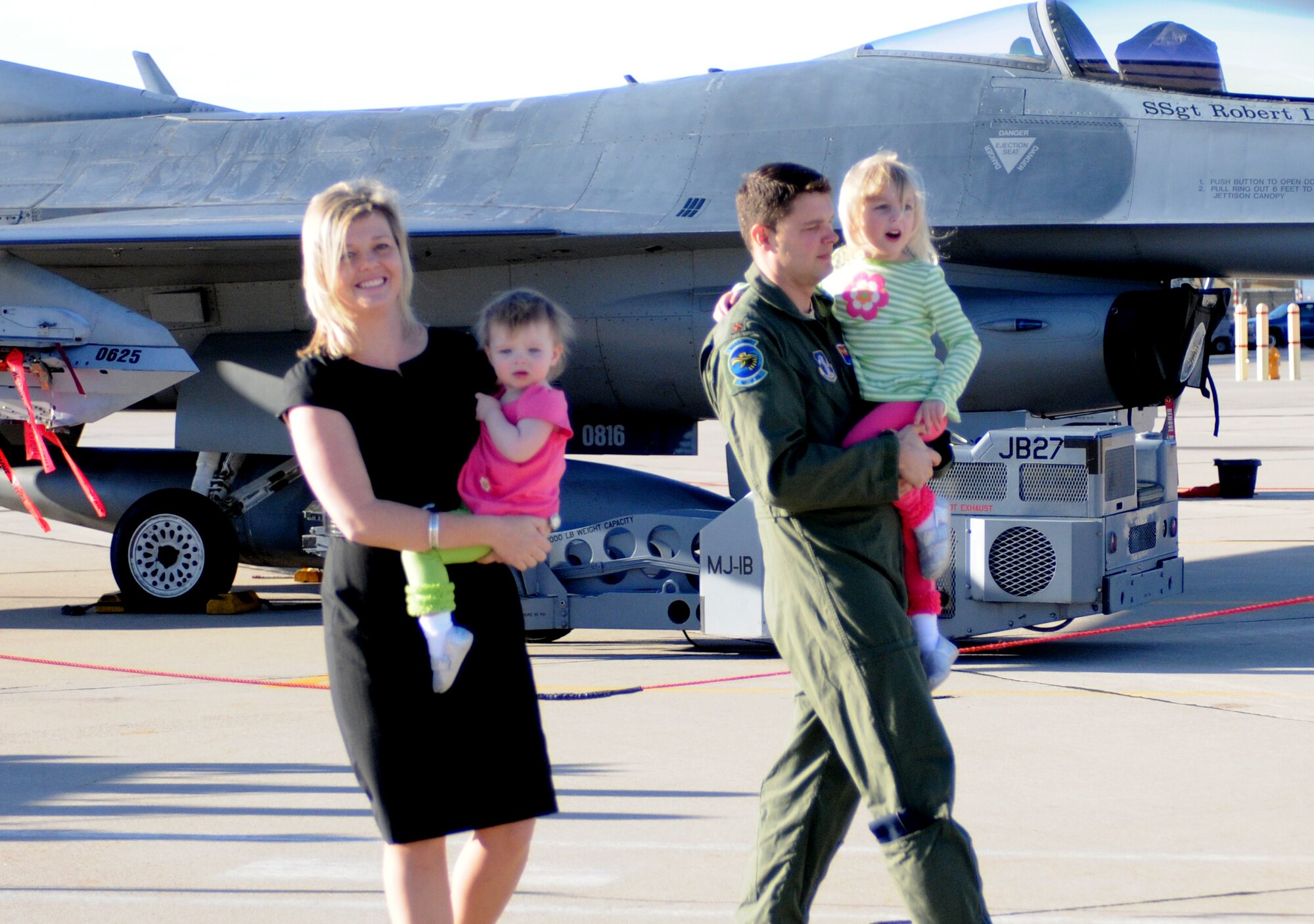 Mary Reding and Maj. John Smith show their daughters an F-16 Fighting Falcon on the 162nd Fighter Wing flightline at Tucson International Airport, Jan. 18. Reding is a National Guard nominee for Military Spouse magazine’s Military Spouse of the Year. If selected, she believes the honor will help her serve military spouses around the country. (U.S. Air Force photo/Maj. Gabe Johnson)