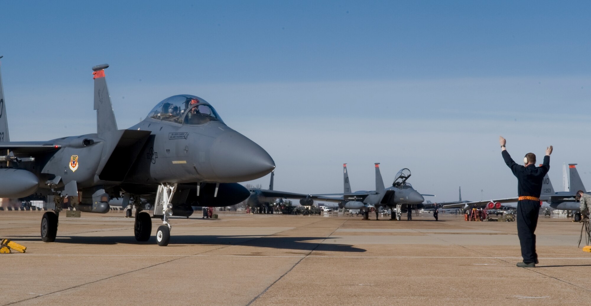 Senior Airman James Roggenbuck, 391st Aircraft Maintenance Squadron crew chief from Mountain Home Air Force Base, Idaho, directs an F-15E Strike Eagle into position on Barksdale Air Force Base, La., Jan. 18. Two hundred twenty five personnel from Mountain Home AFB are at Barksdale to participate in Green Flag. During the exercise, the aircrew practices with soldiers from the Army in combat scenarios to get themselves ready for future deployments. (U.S. Air Force photo/Airman 1st Class Benjamin Gonsier)(RELEASED)

