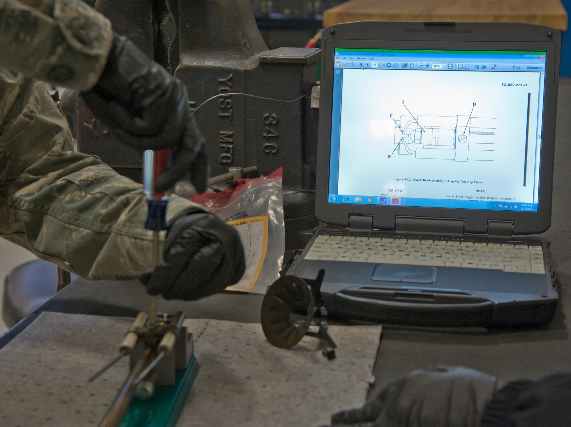 Airman Orlando Macin, 349 Maintenance Squadron, seasonal training program student, follows a technical order on ignition point adjustment demonstrating the four pillars of maintenance, safety, technical data, training and attitude. (U.S. Air Force photo/Airman 1st Class Nicole Leidholm)