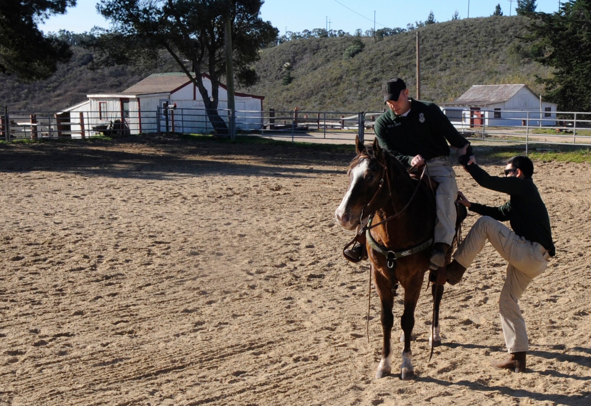 VANDENBERG AIR FORCE BASE, Calif. – Tech. Sgt. Sean Yargus, a 30th Security Forces Squadron conservation officer, and his partner for the day, Six Eagle, practice rescue training with the assistance of Airman 1st Class Zachary Baldenegro, also a 30th Security Forces Squadron conservation officer. The Mounted Horse Patrol unit plays a vital role in base operations to include search and rescue operations and patrols into base territory that even all terrain vehicles cannot access. (U.S. Air Force photo/Tech. Sgt. Scottie T. McCord)