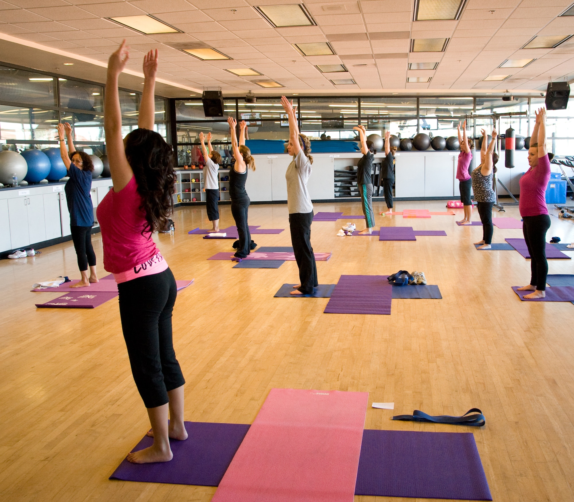 Arielle Sumihig, an Intense PiYo instructor, leads the class in a combination of Pilates and Yoga to increase strength for individuals at the Travis Fitness Center, Calif., January 17. (U.S. Air Force photo/Airman 1st Class Nicole Leidholm)
