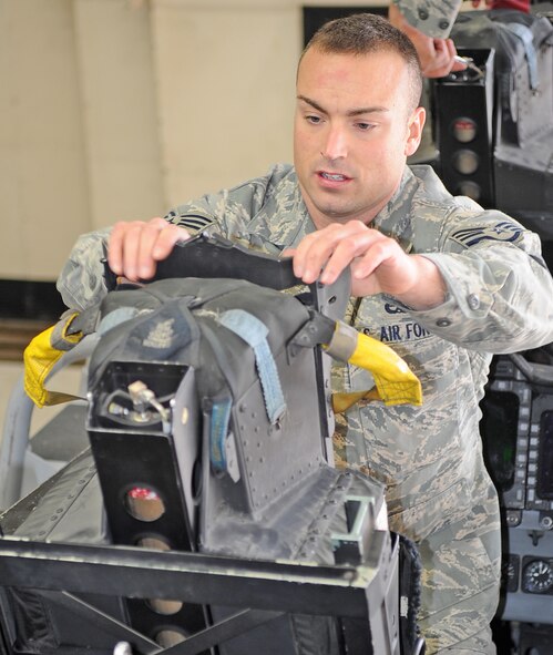 Staff Sgt. Clint Taylor inspects the aft egress system after reinstalling it in an F-15E Strike Eagle at Seymour Johnson Air Force Base, N.C., Jan. 18, 2012. Every 36 months the system is taken out of the aircraft for a Foreign Object and Debris inspection to ensure there was no damage to it. Taylor, 4th Component Maintenance Squadron egress technician, hails from Lexington, Va. (U.S. Air Force photo/Senior Airman Gino Reyes)