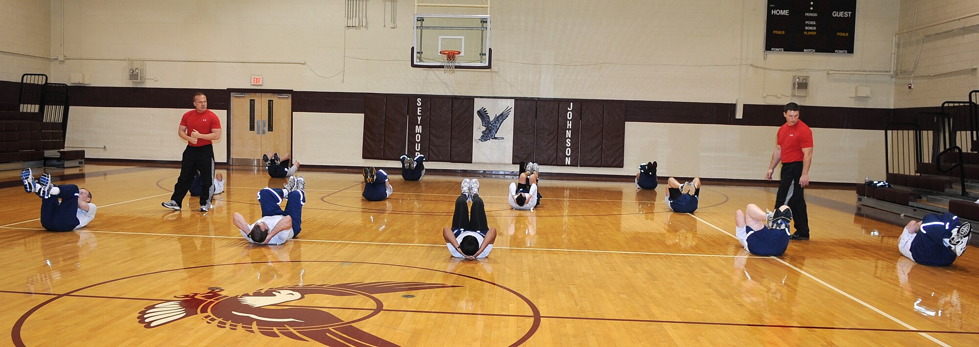 Airmen perform sit-ups during the Fitness Improvement Training program in the fitness center on Seymour Johnson Air Force Base, N.C., Jan. 18, 2011. The program is a high impact 90-minute physical training session that pushes Airmen to their limits. (U.S. Air Force photo/Senior Airman Gino Reyes)