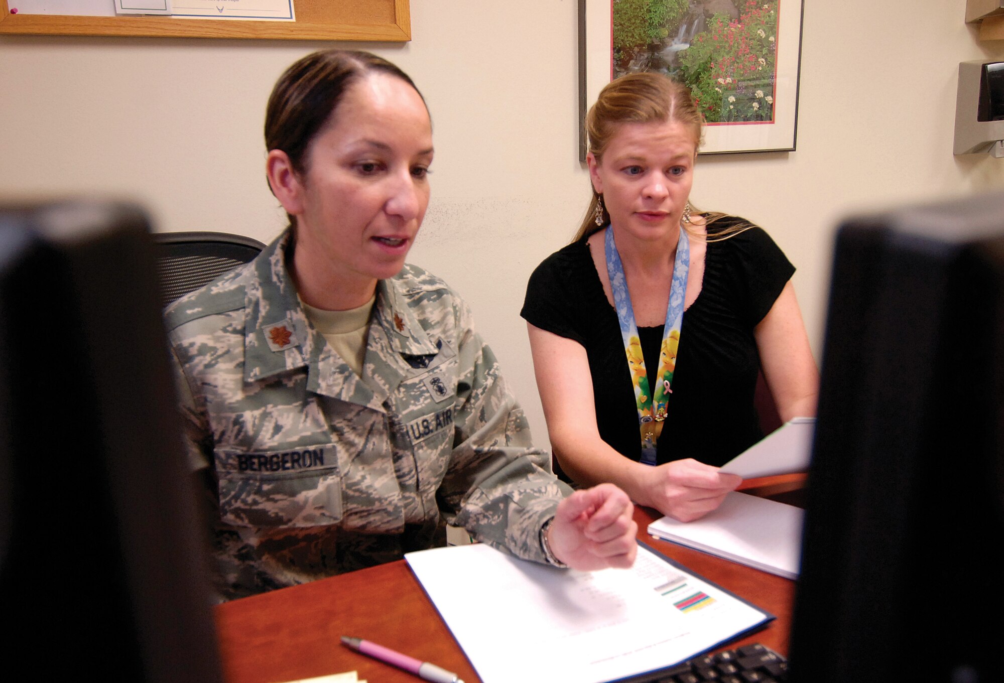 Maj. Isabella Bergeron, 72nd Medical Group Family Health Clinic flight commander, and Jeana Love, Referral Management Center manager,  plan an off-base referral for a patient. The MDG recently held a Rapid Improvement Event to improve that process. (Air Force photos by Margo Wright)