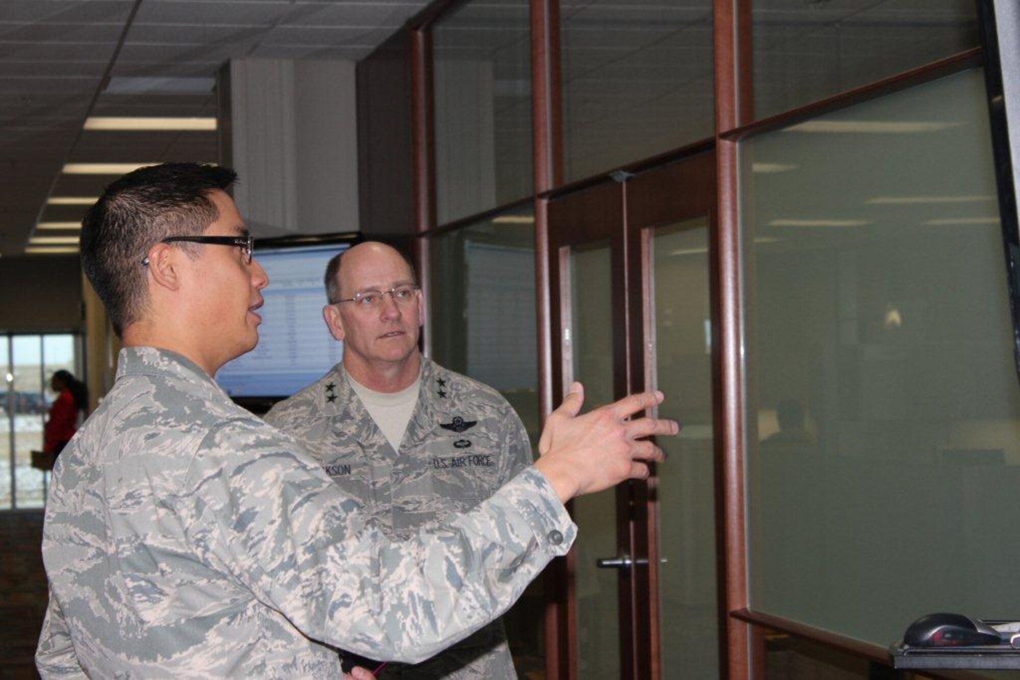 Maj. Gen. James F. Jackson, Deputy to the Chief of Air Force Reserve, is briefed on Total Force Service Center operations Lt. Col. Michael Ortiz, Air Reserve Personnel Center contact center operations chief, during his visit to Jan. 12, 2012, on Buckley Air Force Base, Colo. (U.S Air Force photo/Lt. Col. Tricia York) 