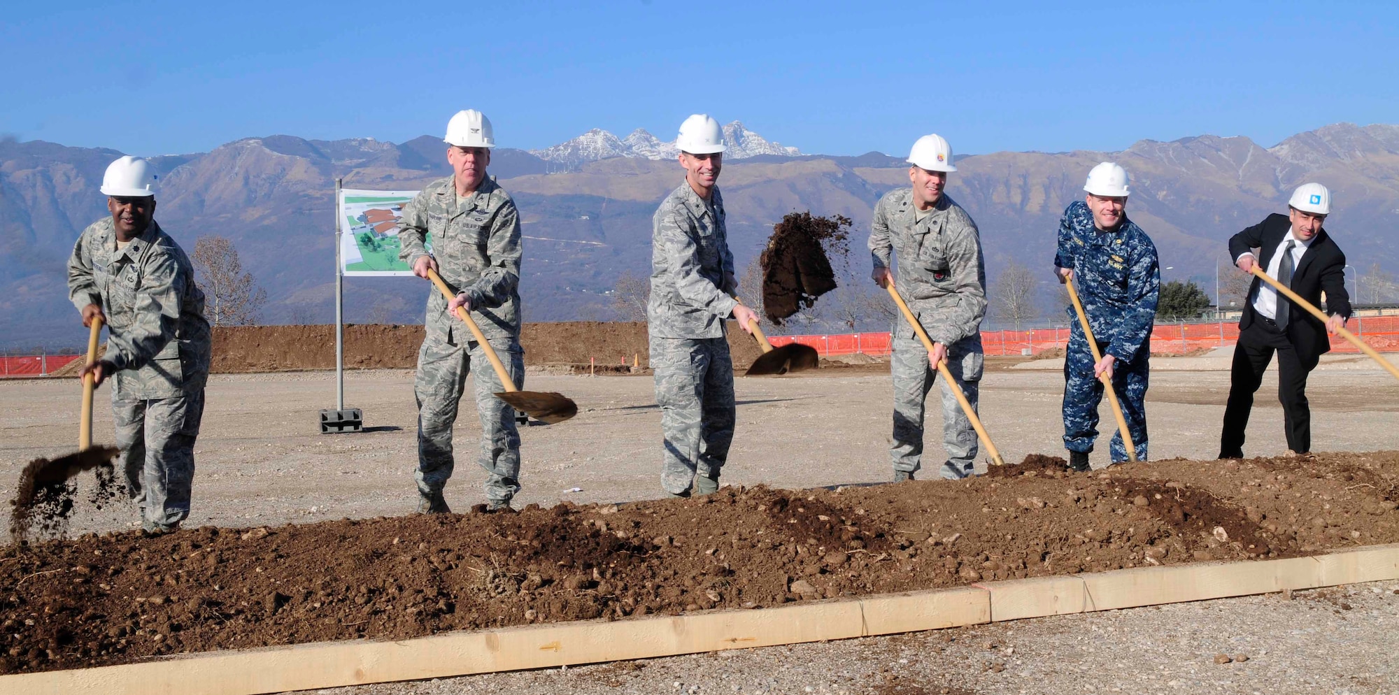 Distinguished visitors break ground during a ceremony for the new 8th Air Support Operations Squadron building Jan. 12 at Aviano Air Base, Italy. The new facility will collocate 8th ASOS with its air support and provide space for administrative operations, training, vehicle and equipment maintenance and storage. (U.S. Air Force photo/Airman 1st Class Briana Jones)
