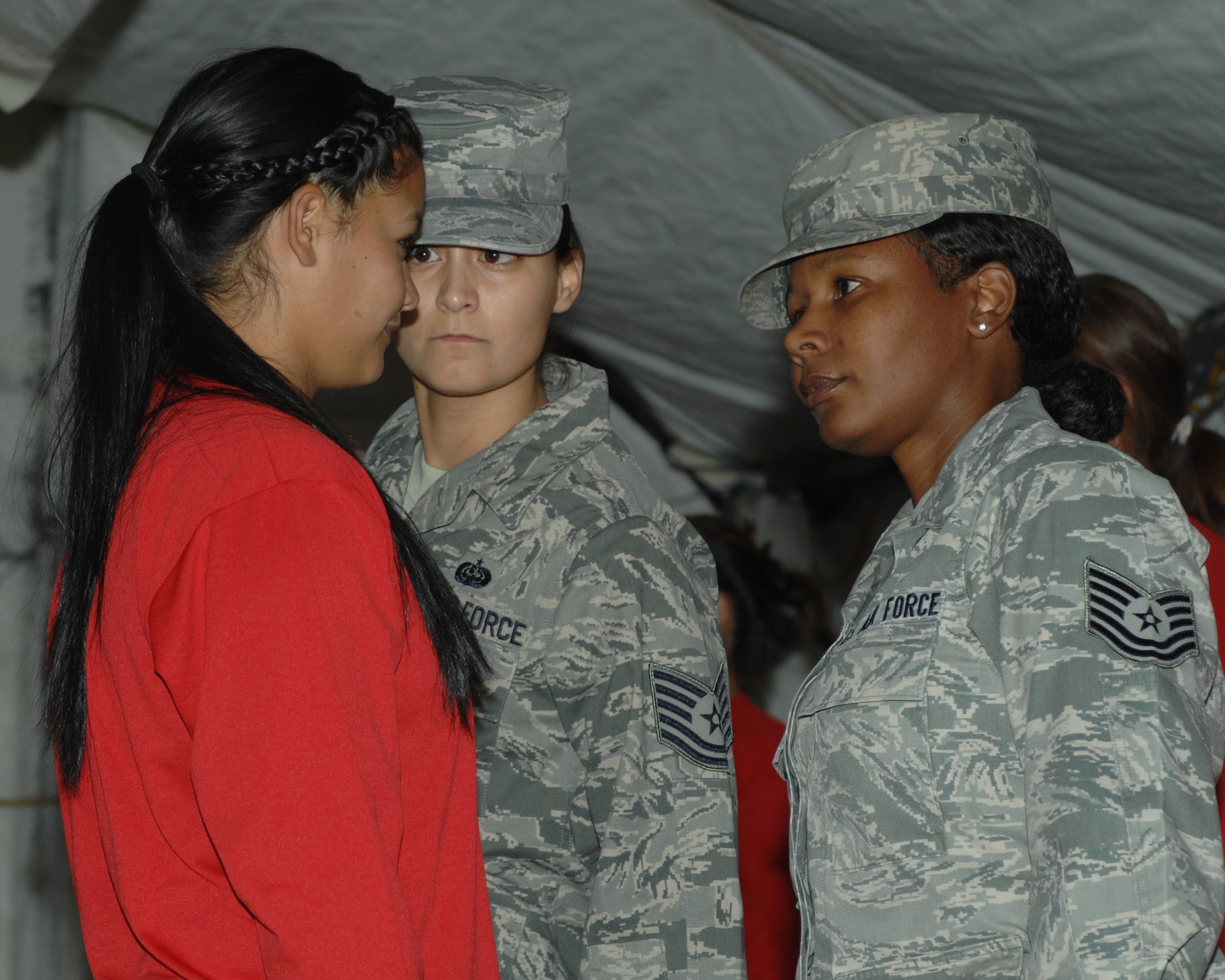 University of Arizona student Brigette Del Ponte, women’s softball team infielder, stands at attention as she is corrected by U.S. Air Force Tech. Sgt. Tibetha Pascal (right) and Tech. Sgt. Carrie Nunez (left), both former military training instructors, on Davis-Monthan Air Force Base, Ariz., Jan. 13, 2012. Del Ponte was caught smiling and was then taught her stay at D-M was a serious one. (U.S. Air Force photo by Airman 1st Class Josh Slavin/Released)