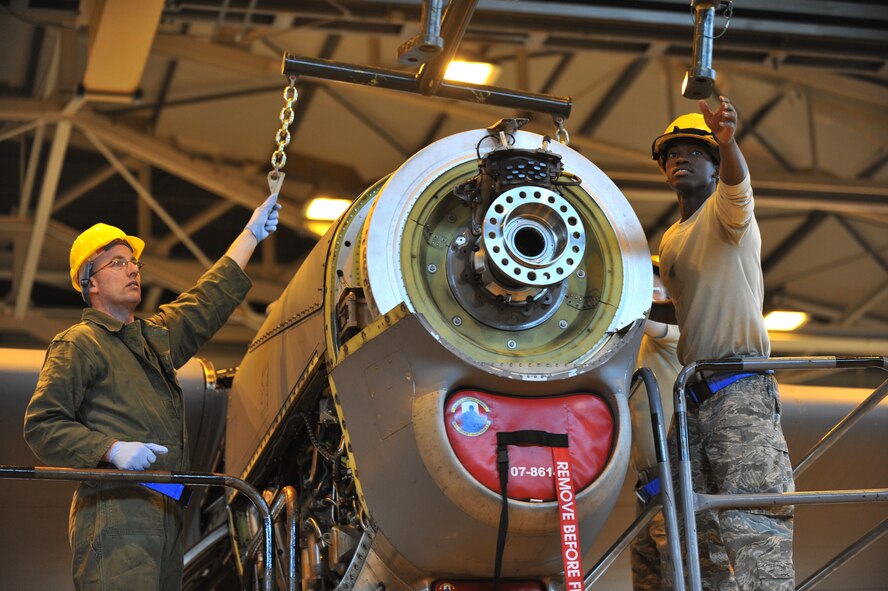 Air Force Airman 1st Class Steven Johnson, 86th Aircraft Maintenance Squadron crew chief,  and Ben Choates, Air Force engineer and air frame technician, prepare to take an engine off of a C-130 J, Ramstein Air Base, Jan. 18, 2012. The engine was damaged by a metal fragment and will take around 8 hours to repair. (U.S. Air Force photo by Airman 1st Class Kendra Alba) 