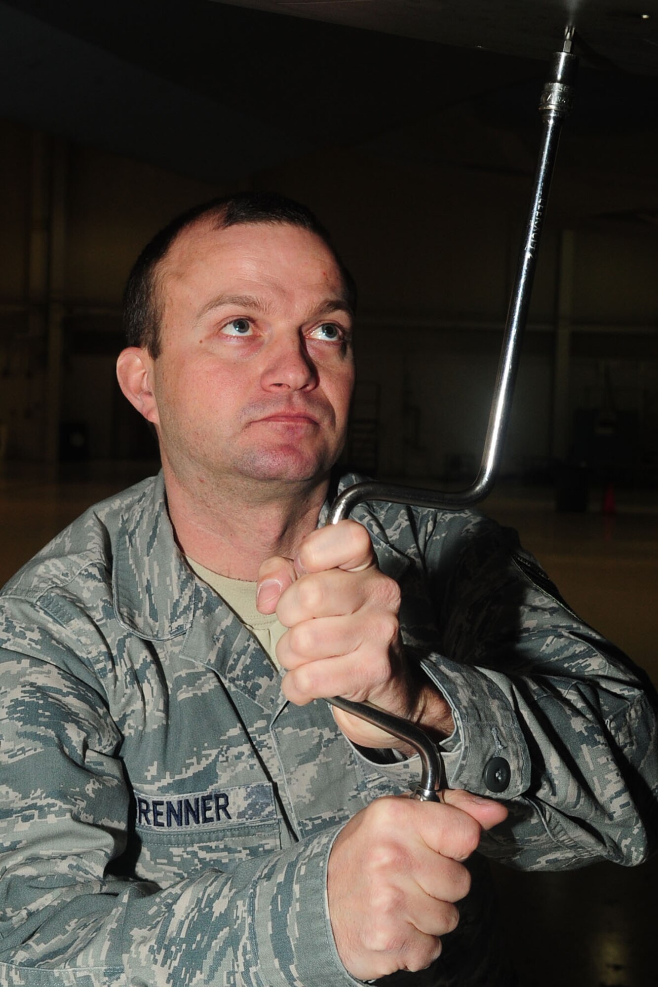 U.S. Air Force Tech. Sgt. Scott Brenner, 1st Maintenance Group package maintenance plan dock chief, places a panel under an F-22 Raptor at Langley Air Force Base, Va., Jan. 17, 2012. The group was the first to successfully generate 18 Raptors in an Operational Readiness Inspection, securing an overall "Excellent" rating. (U.S. Air Force photo by Staff Sgt. Ashley Hawkins/Released)