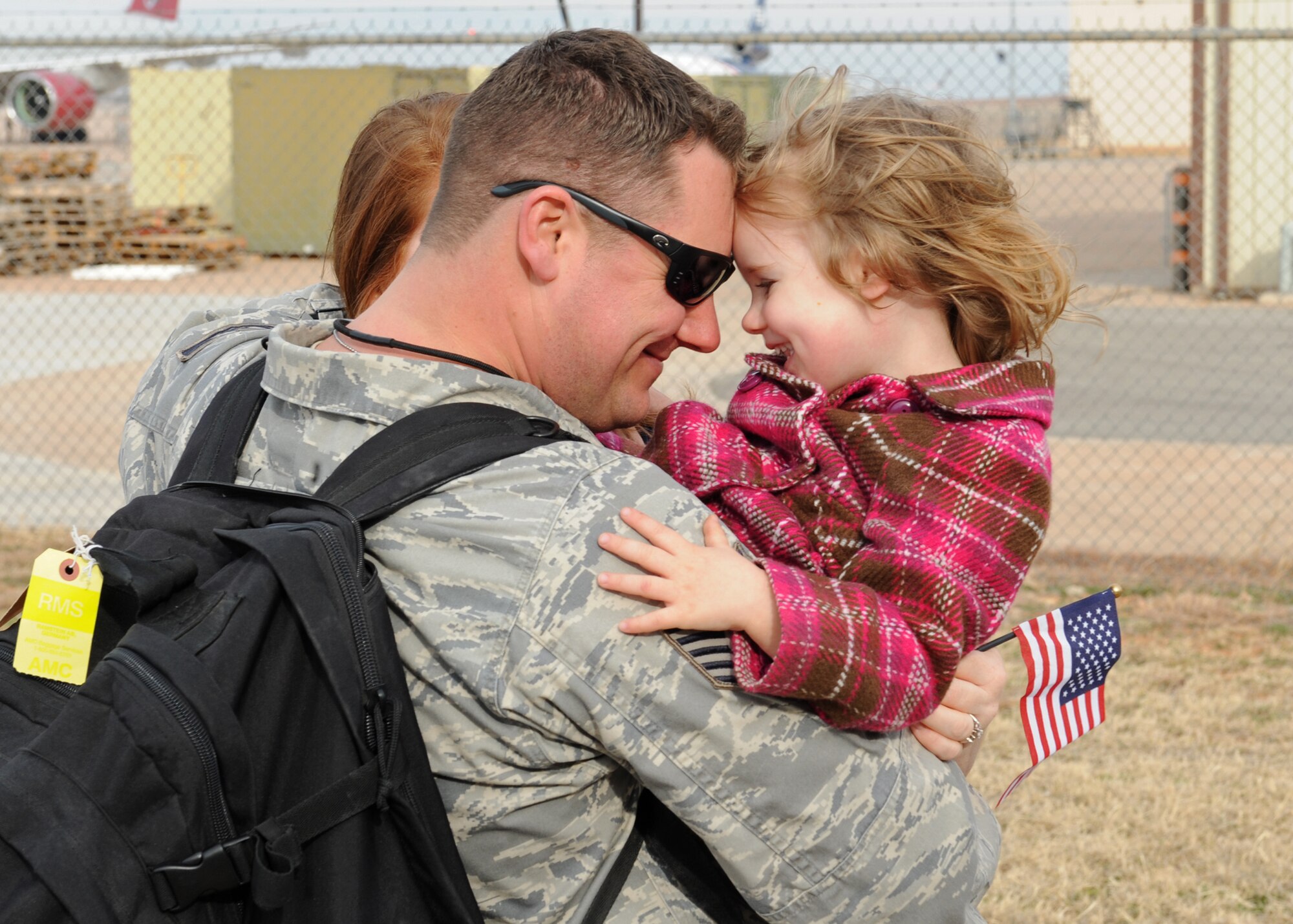Tech. Sgt. Sean Fletcher, 7th Equipment Maintenance Squadron, hugs his daughter, Jan. 16, 2012, after returning to Dyess Air Force Base, Texas. Fletcher returned from a 4-month deployment to Southwest Asia. (U.S. Air Force photo Airman 1st Class Peter Thompson/Released)