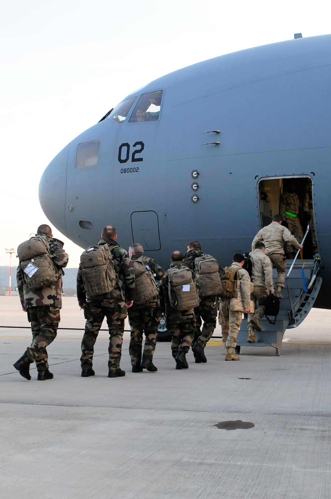 Members of Eurocorps board a C-17 Globemaster III before being deployed to Kabul, Afganastan in support of International Security Assistance Force at Ramstein Air Base, Germany, Jan. 17, 2012. Eurocorps is a multi-national standing army corps available for the European Union and the Atlantic Alliance. (U.S. Air Force photo by Airman 1st Class Kendra Alba)