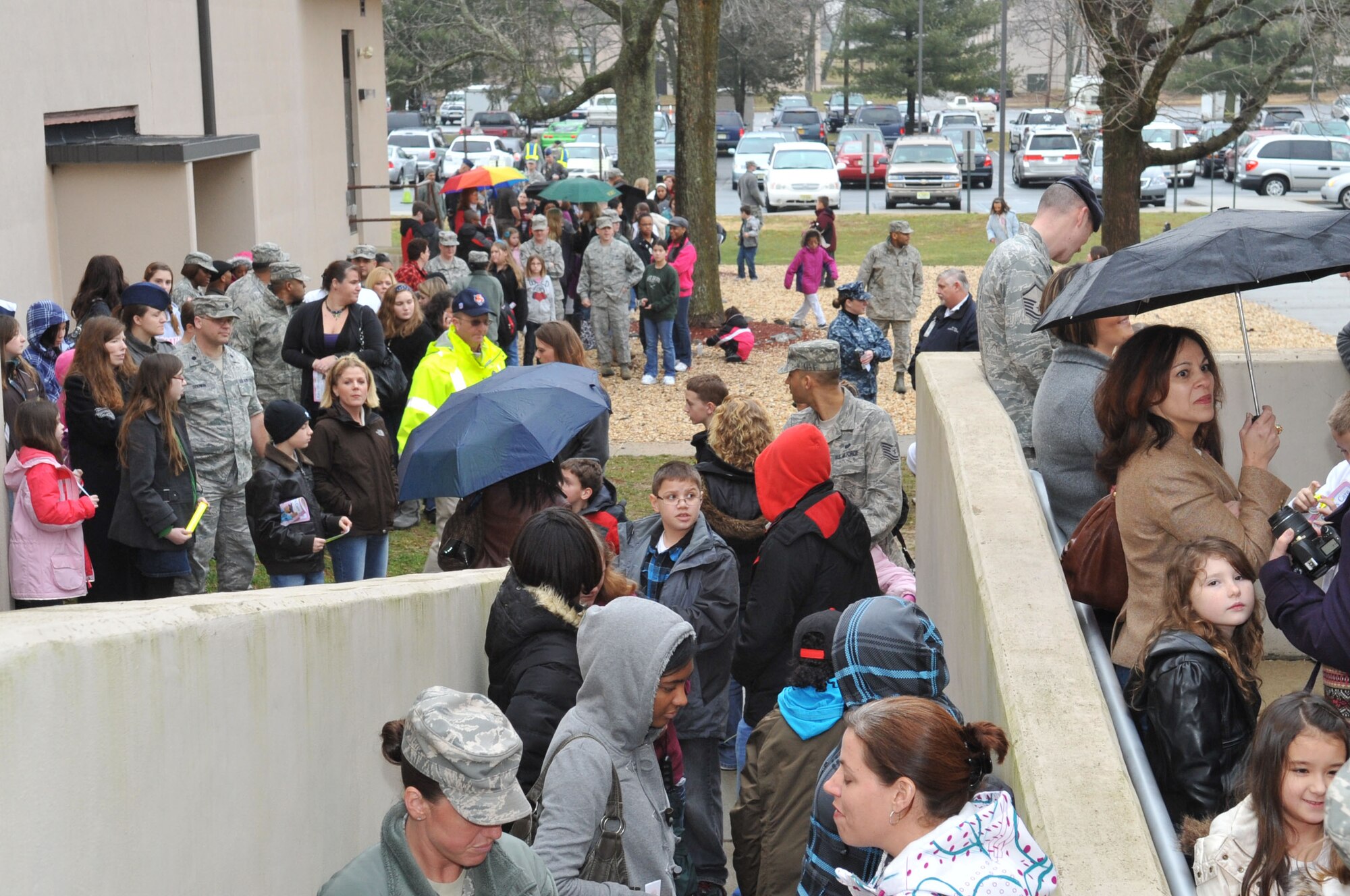 Hundreds of servicemembers and their excited children wait outside the Timmerman Center here Jan. 11, in anticipation of seeing the “iCarly” cast and an exclusive screening of their newest episode. The community members were handed popcorn and glow sticks as they filed into the center for the screening of “iMeet the First Lady,” which features an appearance by Michelle Obama. The iCarly cast made their final stop here during their three-part military installation tour, which spread gratitude to children in military families. (U.S. Air Force photo by Wayne Russell/Released)