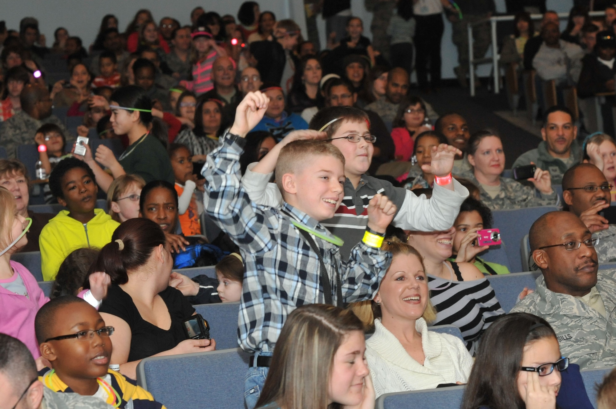 Joint Base McGuire-Dix-Lakehurst children let out an ecstatic cheer at the sight of the “iCarly” cast, leaving their parents ears ringing Jan. 11 at the Timmermann Center. Children filed into the center for the screening of “iMeet the First Lady,” which features an appearance by Michelle Obama. The “iCarly” cast made their final stop here of their three-part military installation tour, which spread gratitude to children in military families. (U.S. Air Force photo by Wayne Russell/Released)