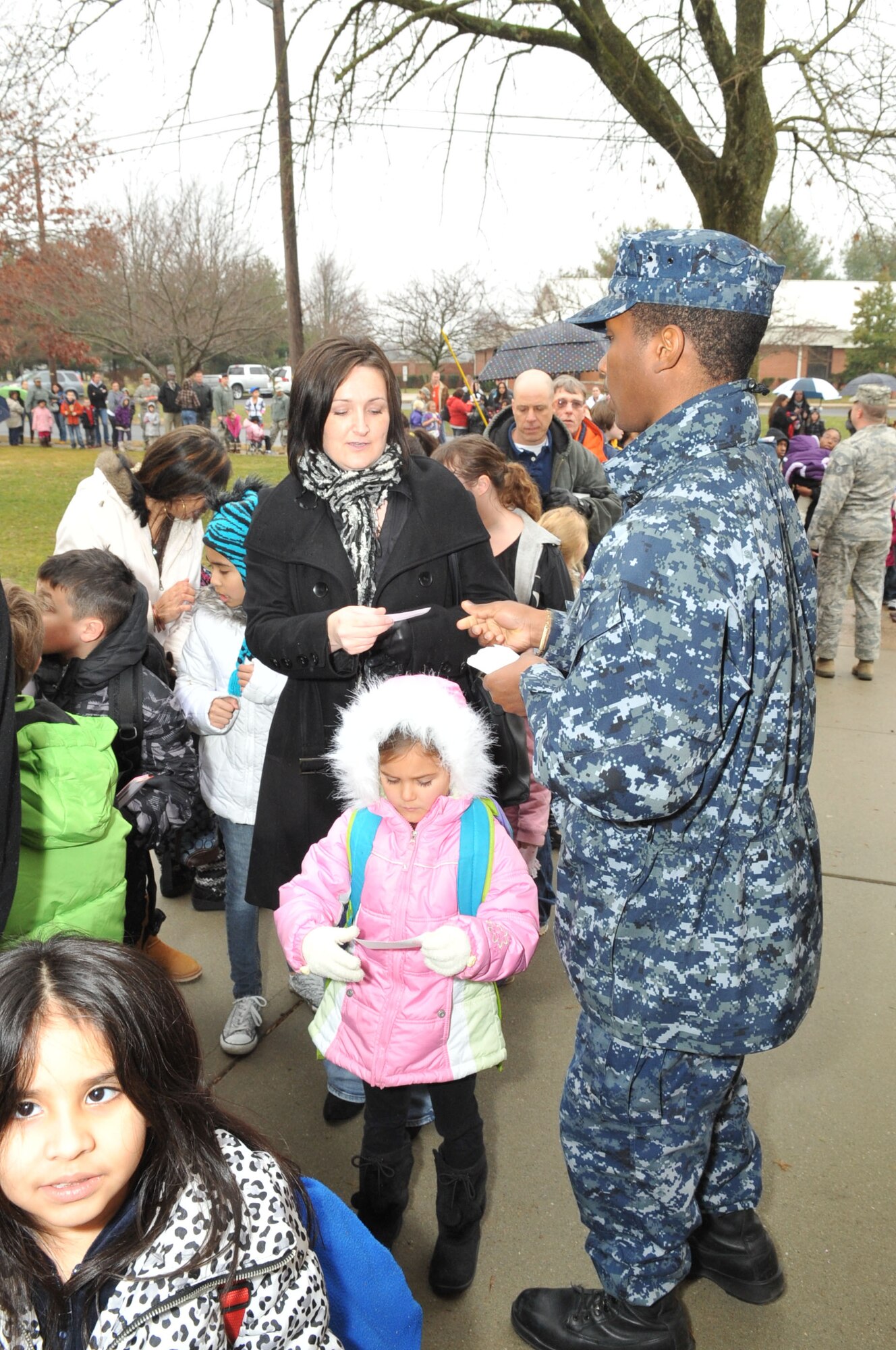 Petty Officer 2nd Class Darren Grant, Joint Base McGuire-Dix-Lakehurst Public Affairs Office member, hands out tickets to the first 200 community members who showed up at the Timmermann Center Jan. 11 for the “iCarly” event. More than 300 tickets were given to unit leadership throughout JB MDL to distribute to servicemembers and their families within the command. Everyone who showed up to the screening was able to get a seat. (U.S. Air Force photo by Wayne Russell/Released)