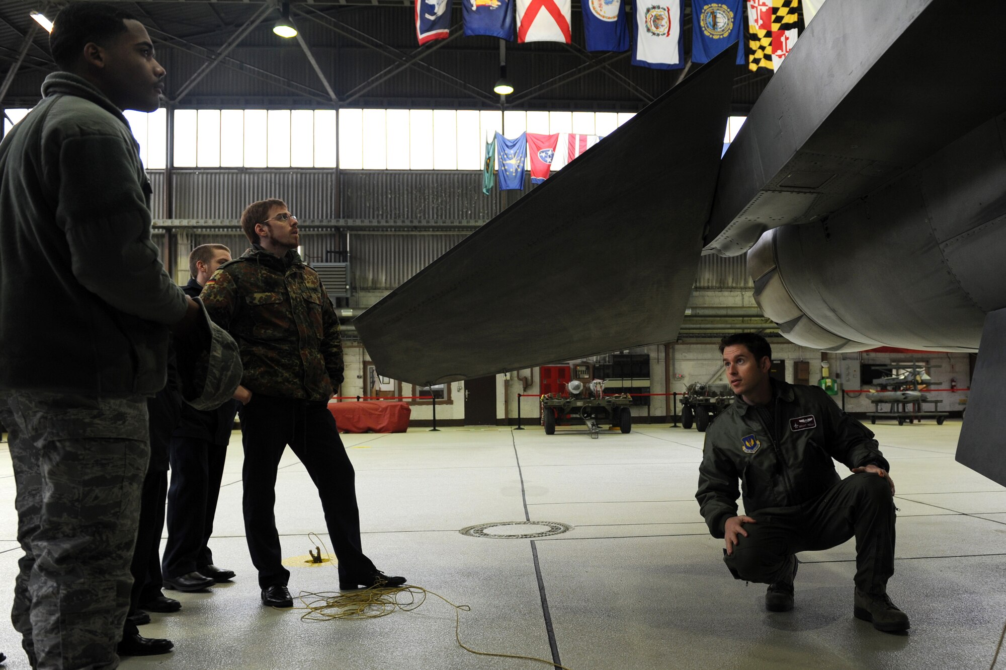 SPANGDAHLEM AIR BASE, Germany – U.S. Air Force Capt. Brant Reilly, 52nd Operations Support Squadron chief of wing weapons and tactics, talks with German air force members from the 10th Advance Air Mission Control Course in Erndtebrueck Bundeswehr about the capabilities of the F-16 Fighting Falcon. Students from the 10th AAMC visited Spangdahlem AB to gain a better understanding of the operations and capabilities of the 606th Air Control Squadron and the 52nd Fighter Wing’s fighter squadrons. (U.S. Air Force photo/Airman 1st Class Matthew B. Fredericks)