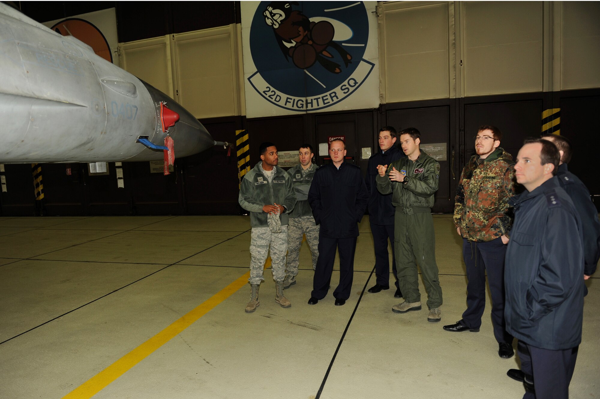SPANGDAHLEM AIR BASE, Germany – U.S. Air Force Capt. Brant Reilly, middle, 52nd Operations Support Squadron chief of wing weapons and tactics, talks with German air force members from the 10th Advance Air Mission Control Course in Erndtebrueck Bundeswehr about the capabilities of the F-16 Fighting Falcon. Students from the 10th AAMC visited Spangdahlem AB to gain a better understanding of the operations and capabilities of the 606th Air Control Squadron and the 52nd Fighter Wing’s fighter squadrons. (U.S. Air Force photo/Airman 1st Class Matthew B. Fredericks)
