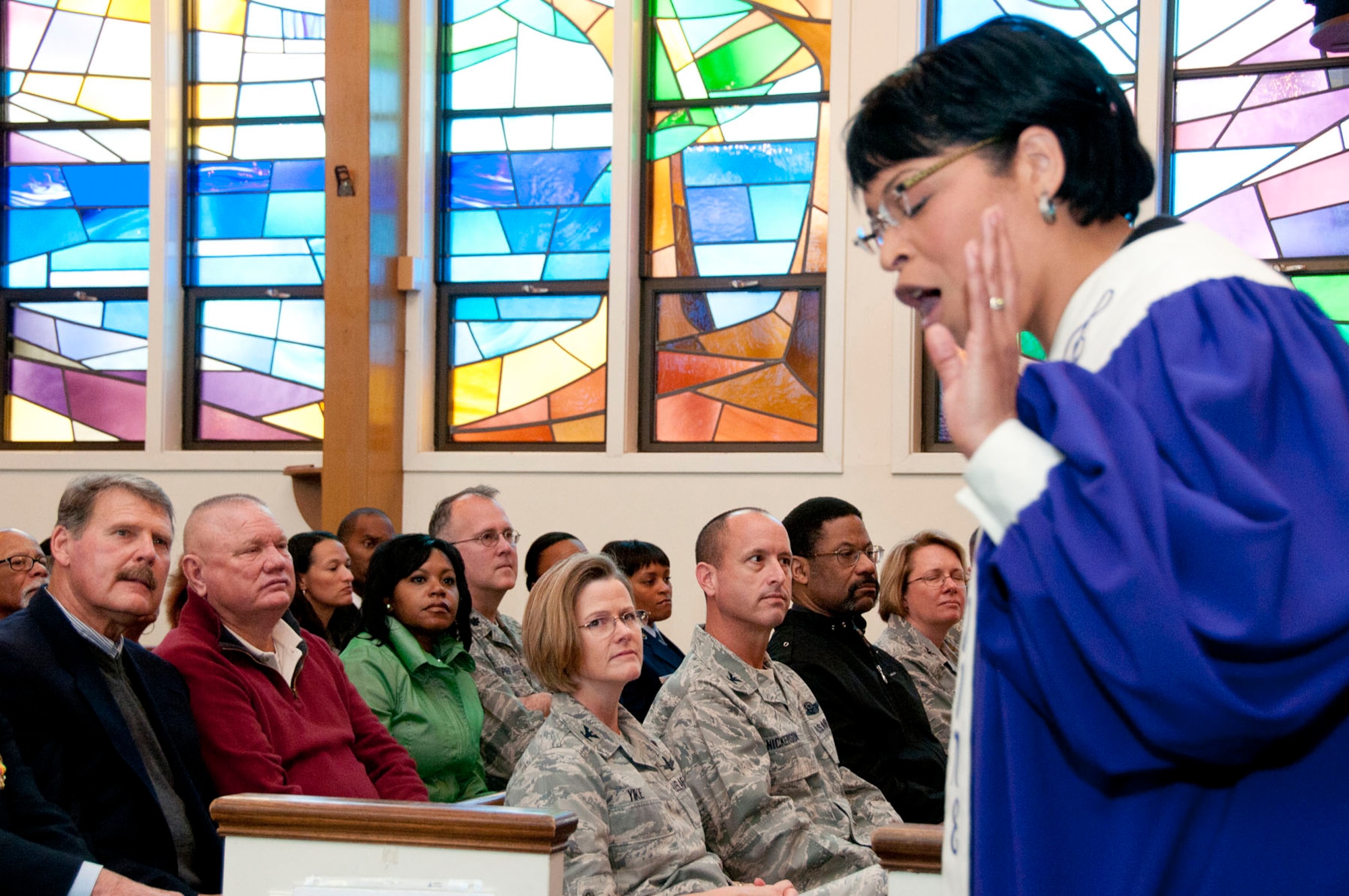 HANSCOM AIR FORCE BASE, Mass. – Attendees listen as Angelena Kyles, a member of the Unified Voices of New England, performs at the Dr. Martin Luther King Jr. celebration at the base chapel on Jan. 12. UVNE is an a cappella choir consisting of members of the Church of Christ from the New England area. (U.S. Air Force photo by Mark Wyatt)