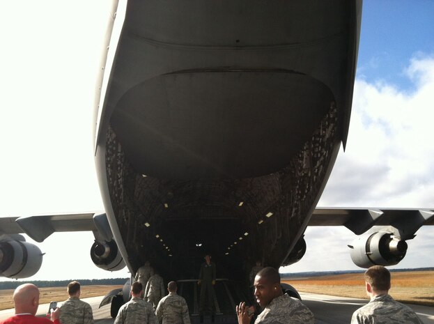 Airmen, Sailors and civilian personnel at Joint Base Charleston – Air Base enter the C-17 Globemaster III after eating lunch while the crew demonstrated two assault landings for training purposes. The quarterly Incentive Flight was held on Jan. 12. (U.S. Air Force Photo/Airman 1st Class Tom Brading)