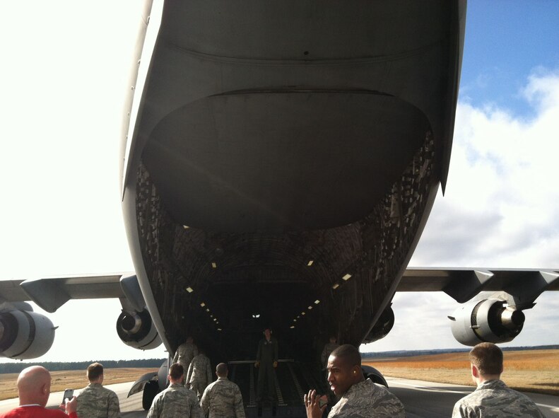 Airmen, Sailors and civilian personnel at Joint Base, S.C., enter a C-17 Globemaster III after eating lunch while the crew demonstrated two assault landings for training purposes. The quarterly incentive flight was held Jan. 12, 2012. (U.S. Air Force Photo/Airman 1st Class Tom Brading)