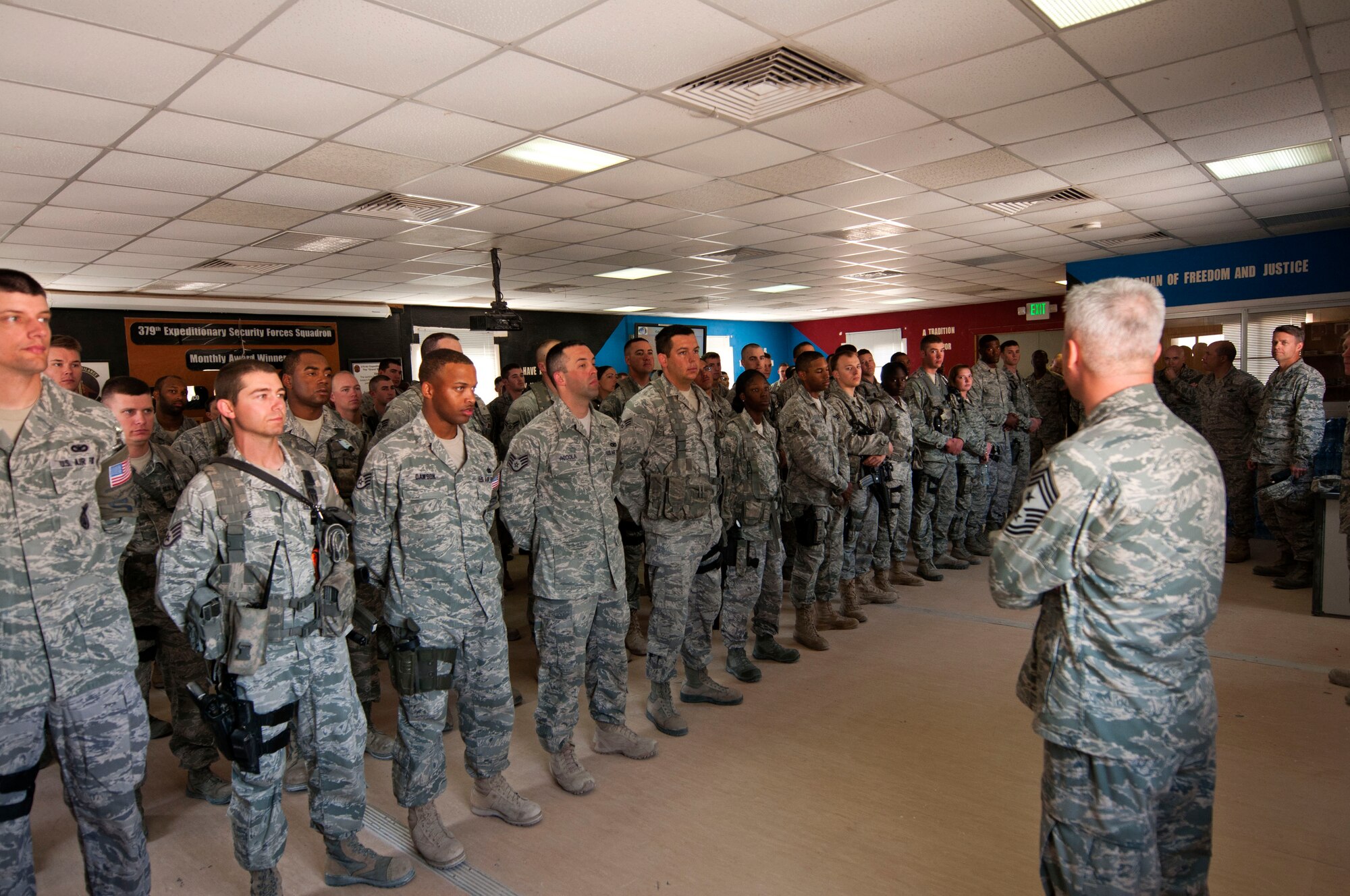 Chief Master Sgt. Robert Sealey, U.S. Air Forces Central command chief, (front right) addresses Airmen from the 379th Expeditionary Security Forces Squadron Jan. 18, 2012. Sealey visited Airmen at several units here to share experiences and to answer questions about current issues. (U.S. Air Force photo/Staff Sgt. David Salanitri)