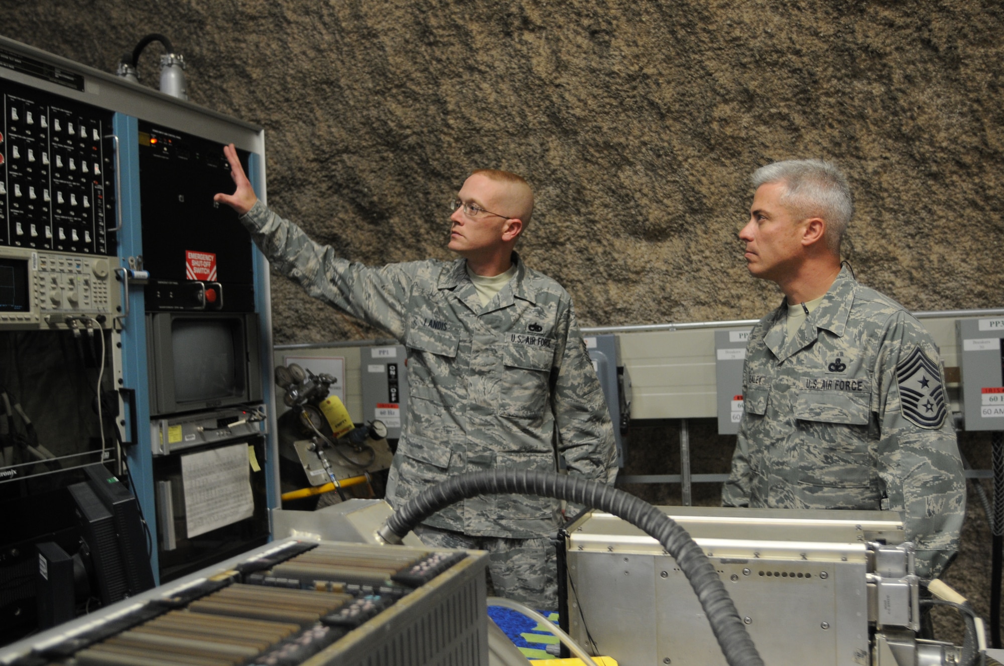 Tech. Sgt. Matthew Landis, 379th Expeditionary Maintenance Squadron avionics production supervisor, explains the purpose of a B-1 avionics test station to Chief Master Sgt. Robert Sealey, U.S. Air Forces Central command chief, during a visit to the squadron’s avionics intermediate section Jan. 18, 2012. Sealey visited Airmen at several units here to share experiences and to answer questions about current issues. (U.S. Air Force photo/Master Sgt. Victoria Meyer)