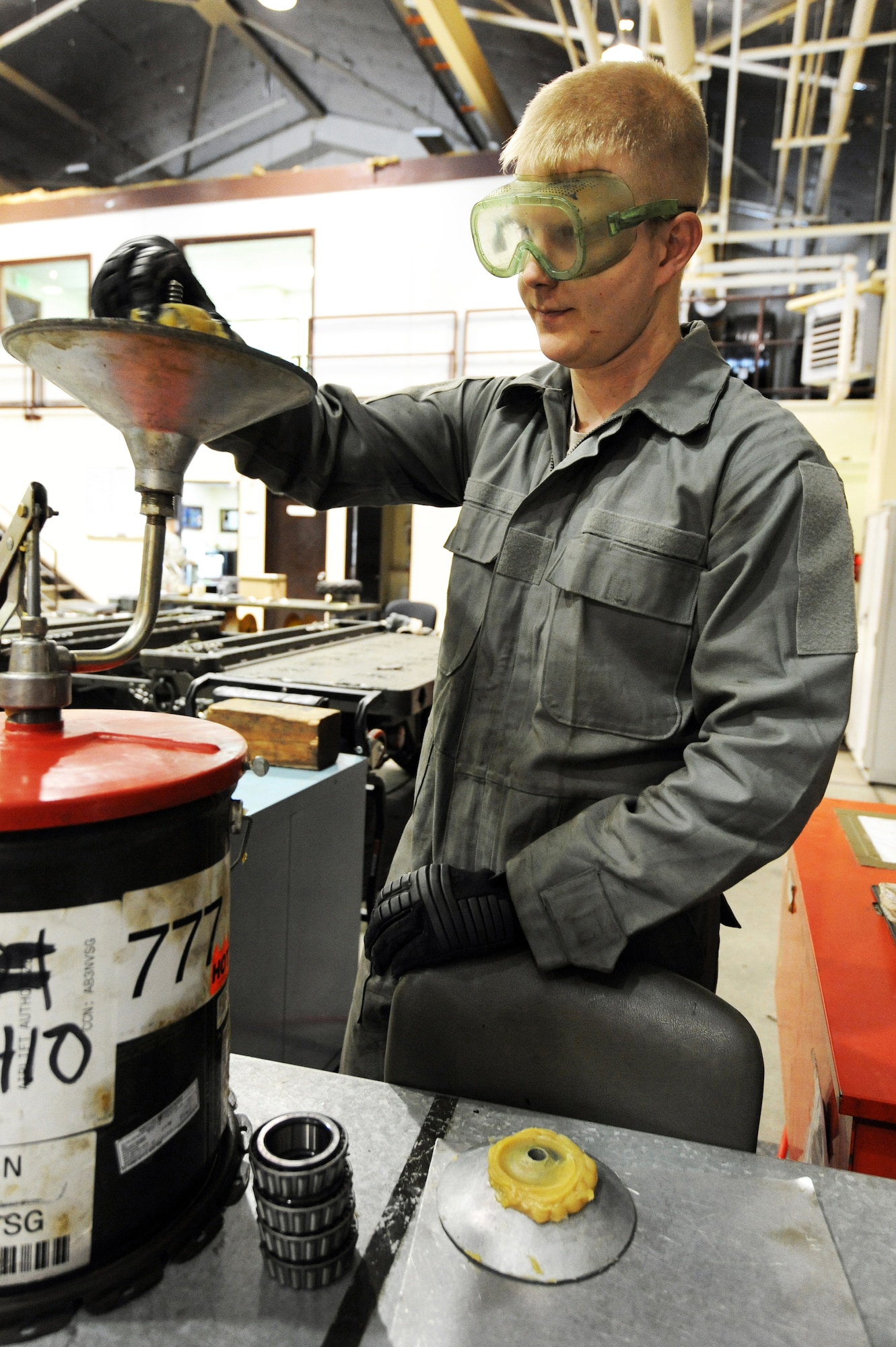 MISAWA AIR BASE, Japan -- Airman 1st Class Cristian Grady, 35th Maintenance Squadron, packs bearings for a Munitions Handling Unit 141 trailer that is due for a 720 day inspection here, Jan. 17. Grady, a Cedar Rapids, Iowa native has been working as a mission support equipment crew member since November 2010. (U.S. Air Force photo/Airman 1st Class Kia Atkins)