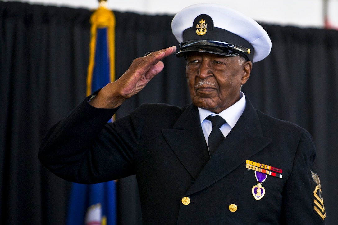 Retired Navy Chief Petty Officer Carl E. Clark salutes Navy Secretary ...